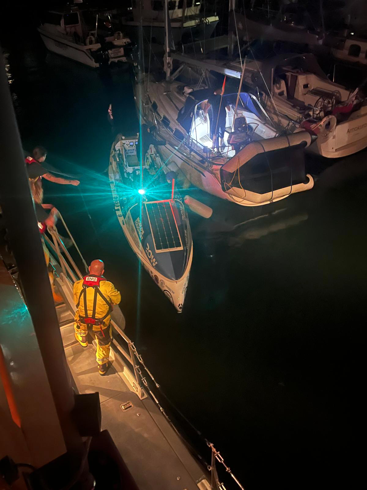 Picture shows RNLI volunteers helping rowers