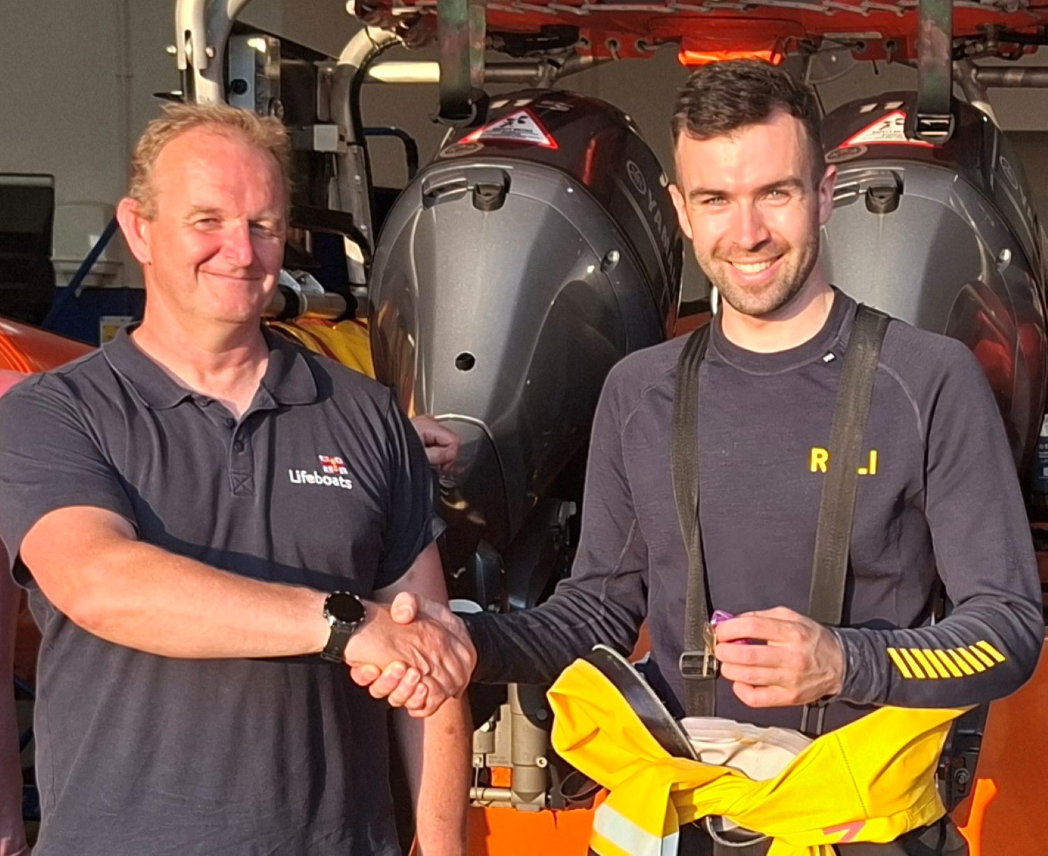 Close up of two crew shaking hands