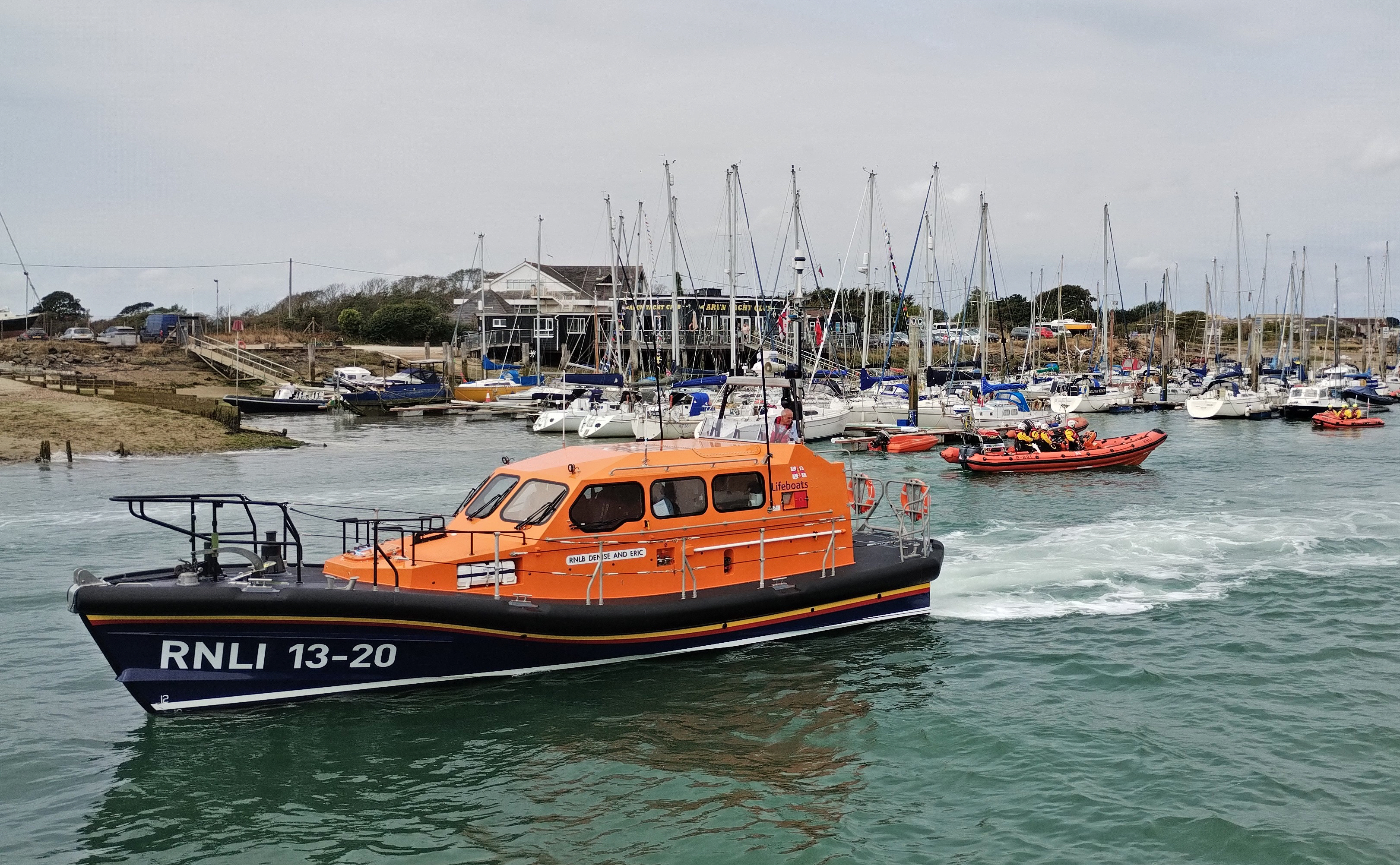 Three lifeboats on a river