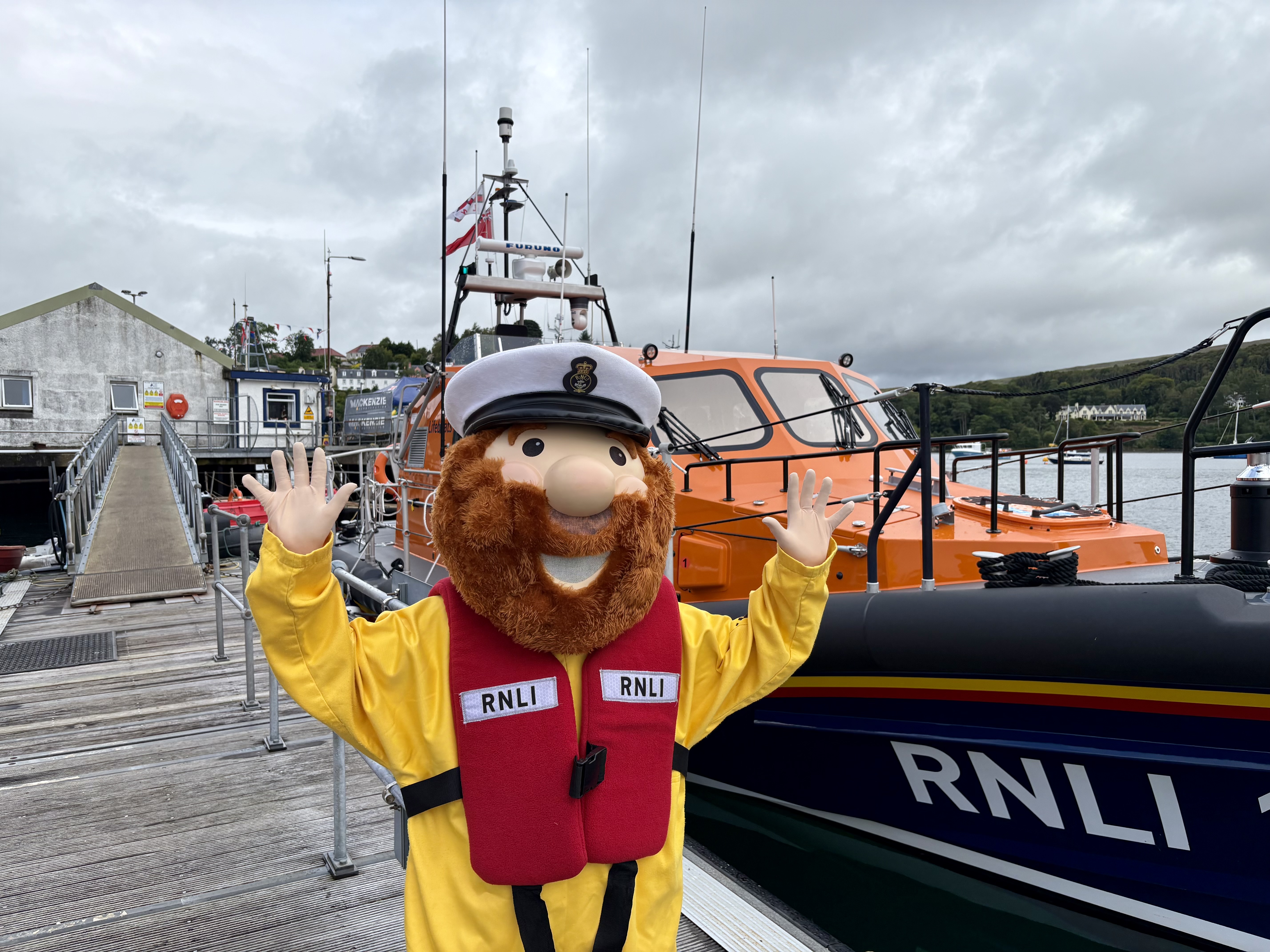 RNLI mascot Stormy Stan pictured beside RNLB Peter and Mary