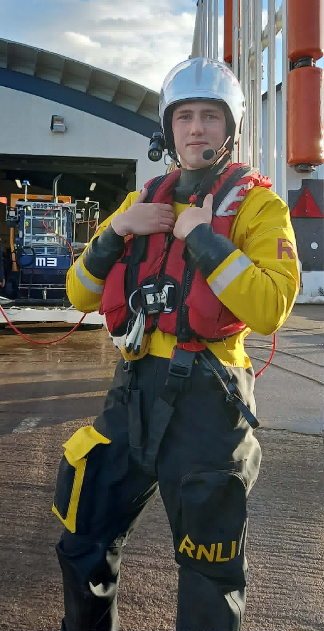 Crew volunteer Timothy with the lifeboat station and trailer in the background