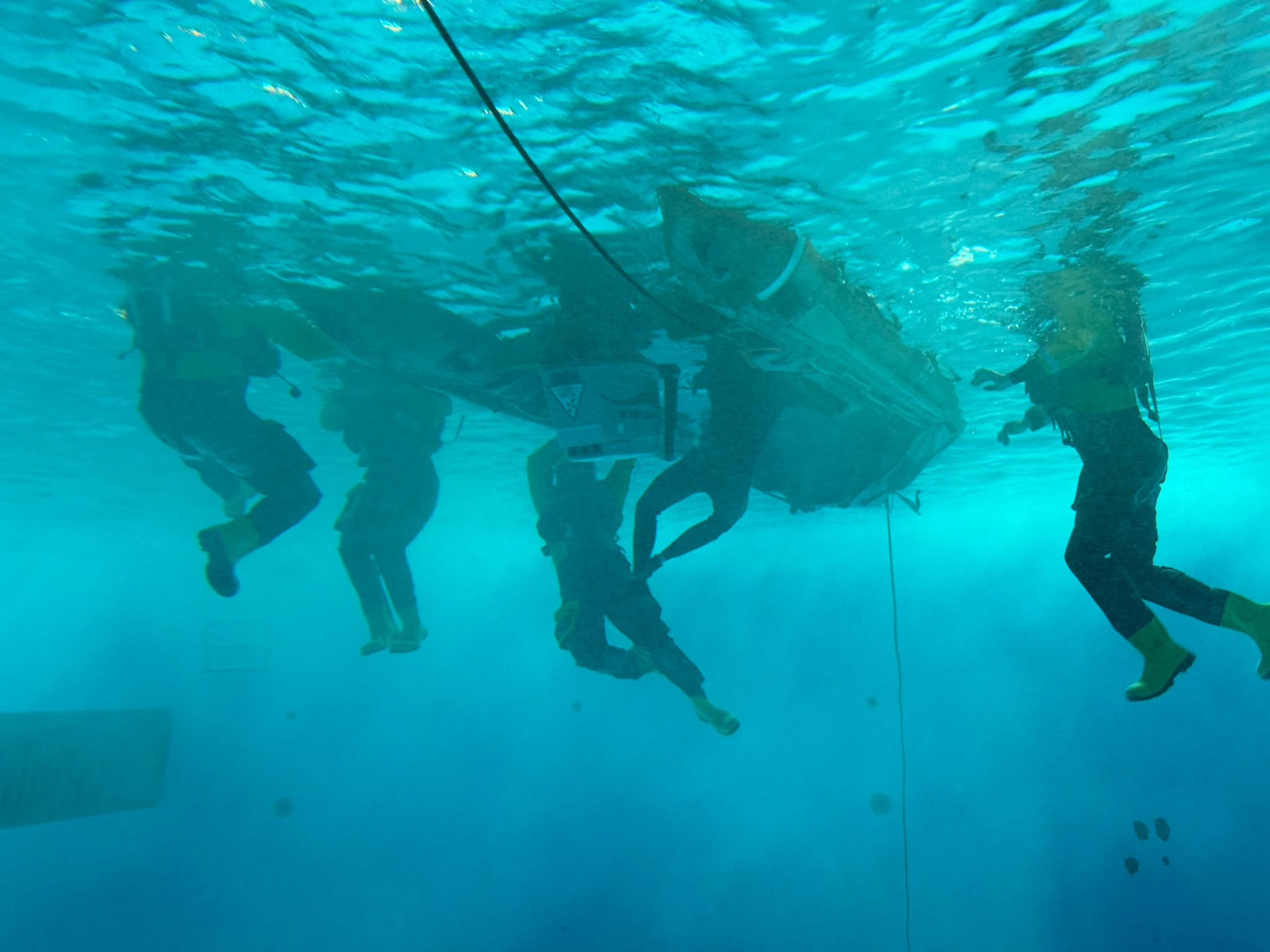 An underwater shot showing trainees trying to right and re-board the vessel