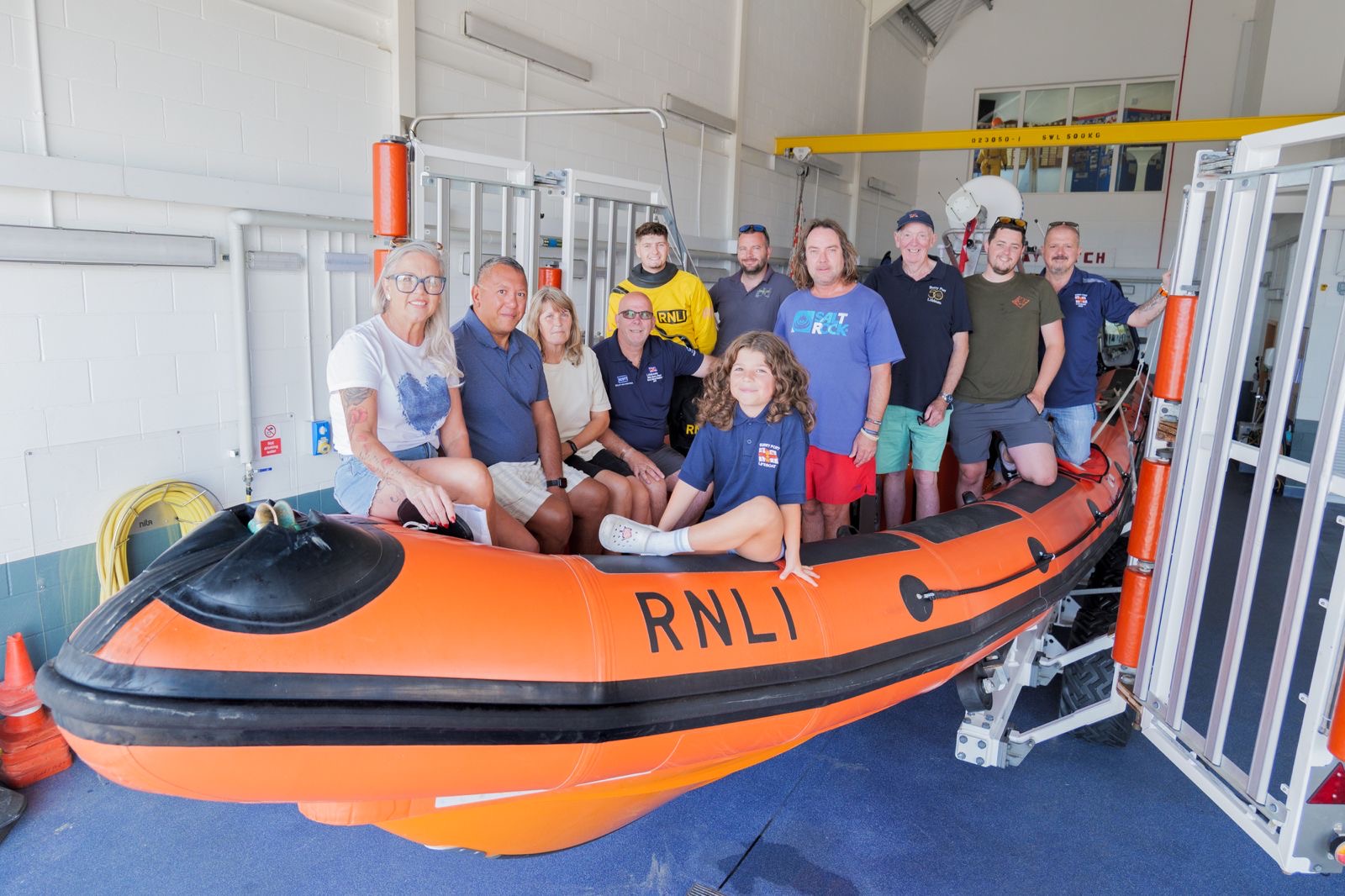 A photo of Leah, her husband and a handful of crew