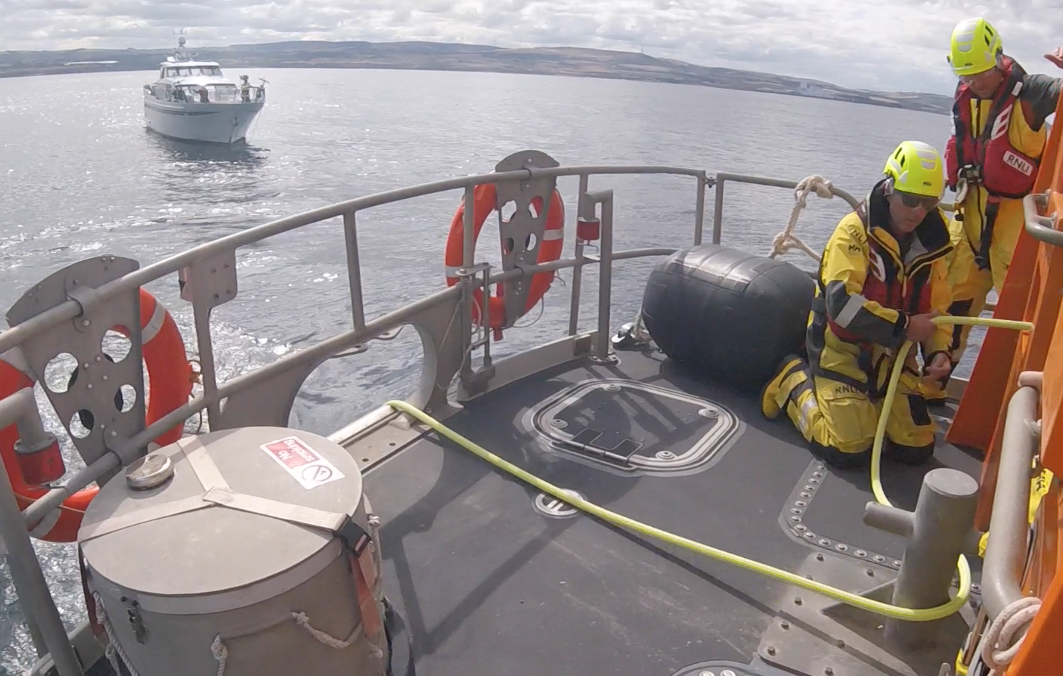 Two men working on deck.
