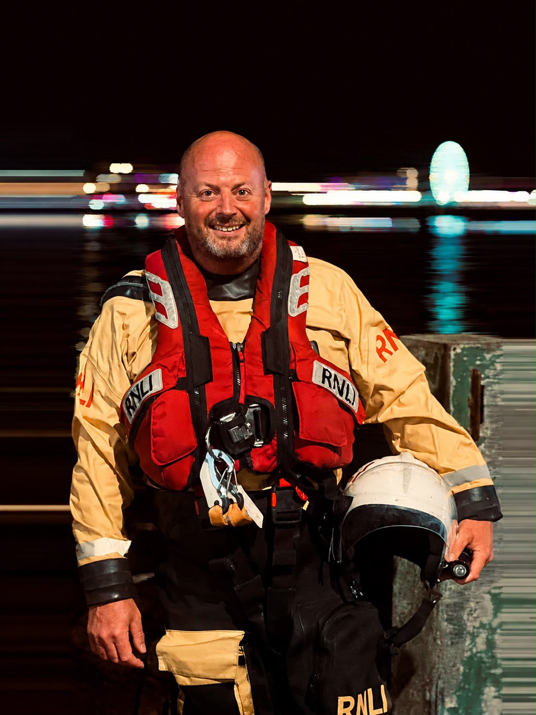 Nigel in full RNLI boat crew kit holding his helmet