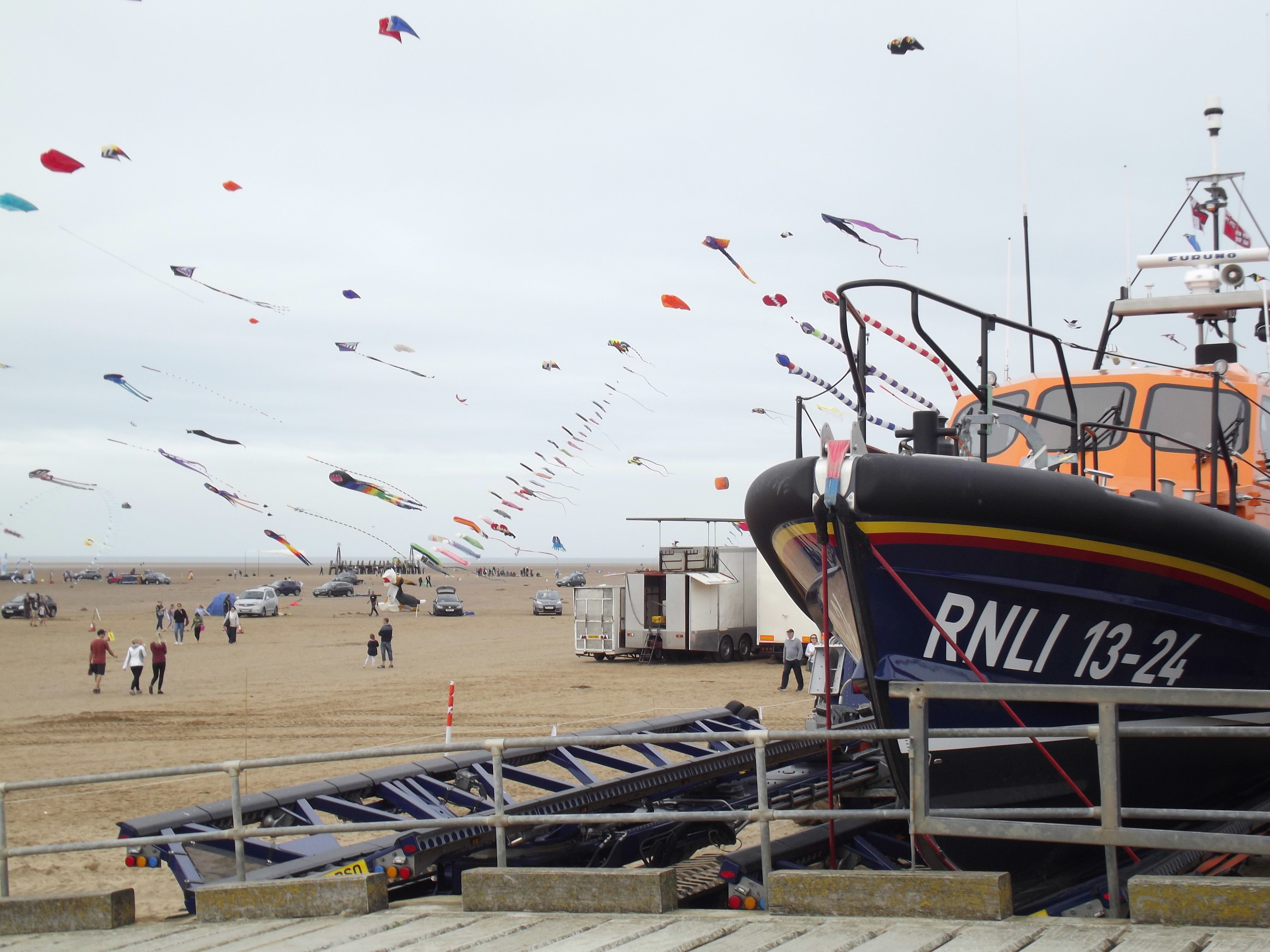 a Lifeboat is shown with a large number of kites flying behind