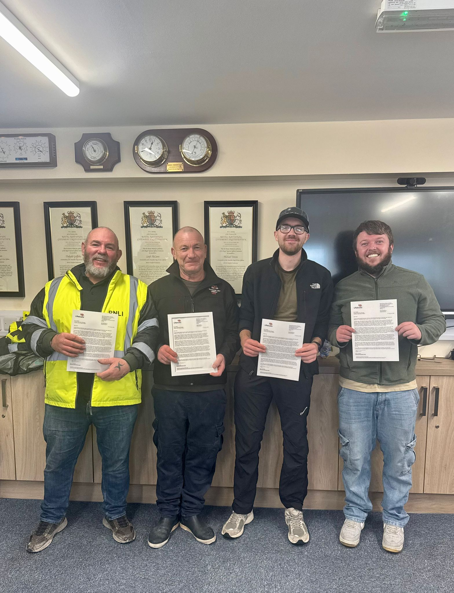 Crew members holding letters of thanks from Regional Operations Lead Ryan Jennings