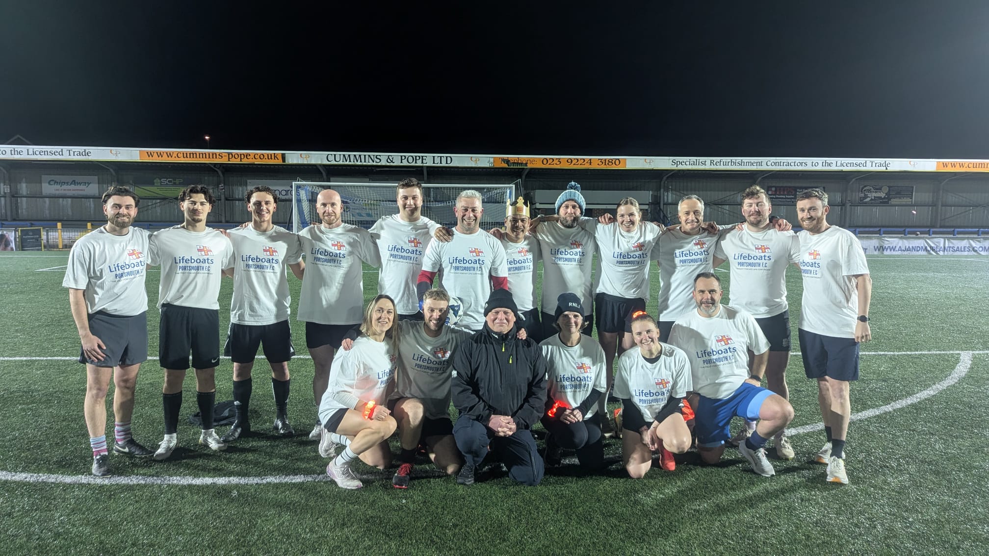Team of footballers and friends posing for a pre-match photo