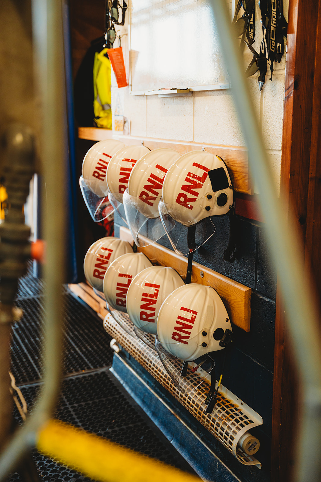 A wall with RNLI helmets hung up. 