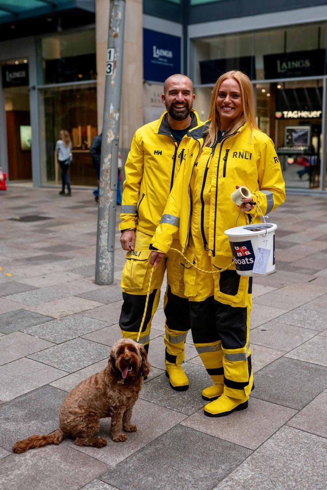 Nick and Jen with Daphne fundraising in RNLI kit holding collecting bucket. 