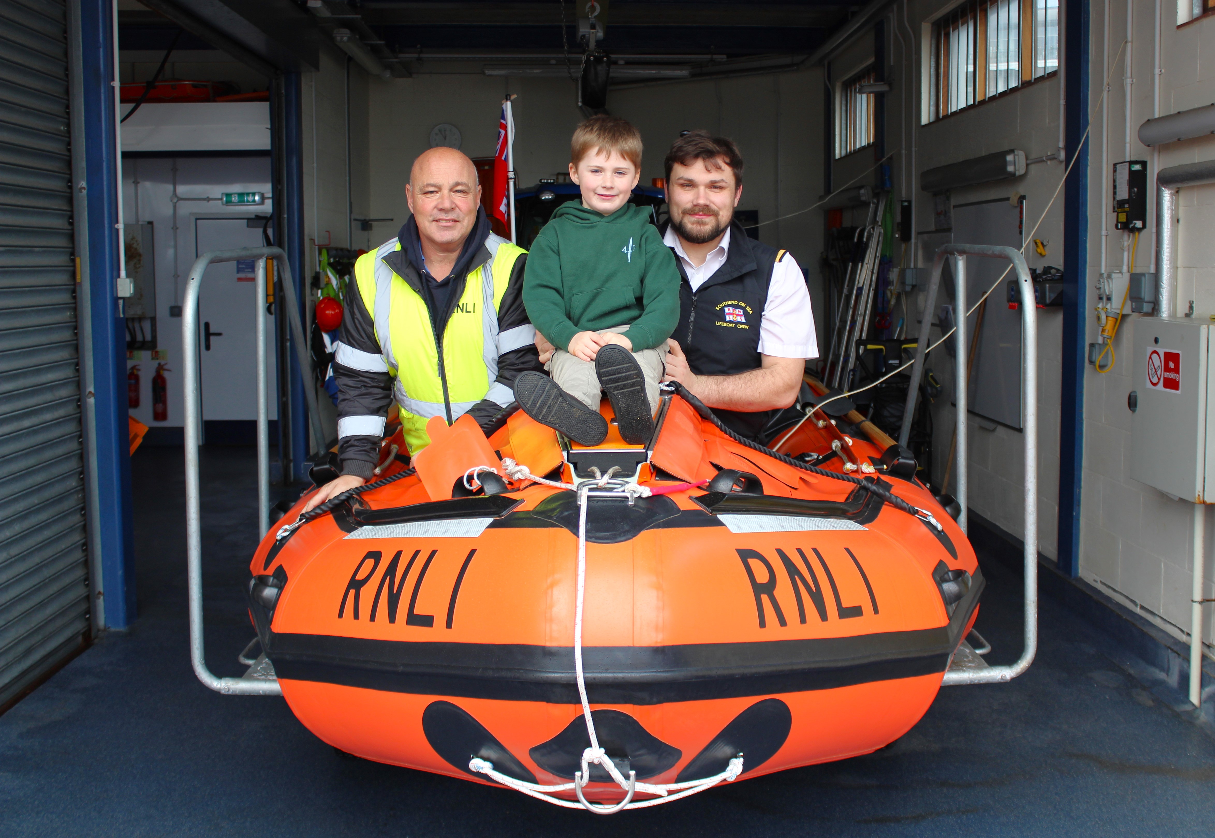 Tony with son Tyler and grandson Noah on the D class lifeboat