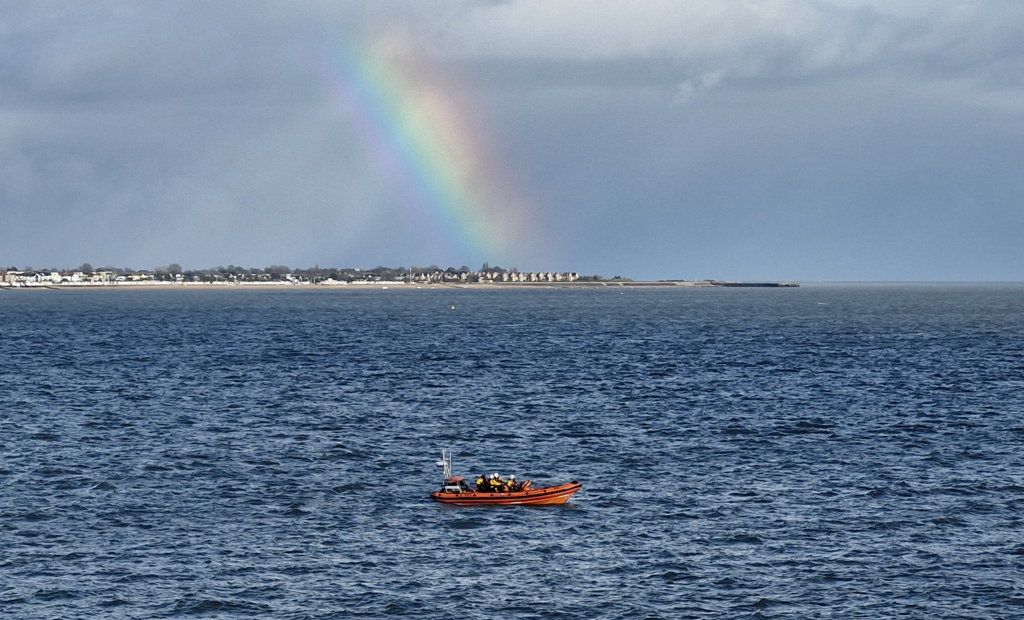 Southend lifeboat B-885 Julia and Angus Wright during assessment with a rainbow behind the lifeboat