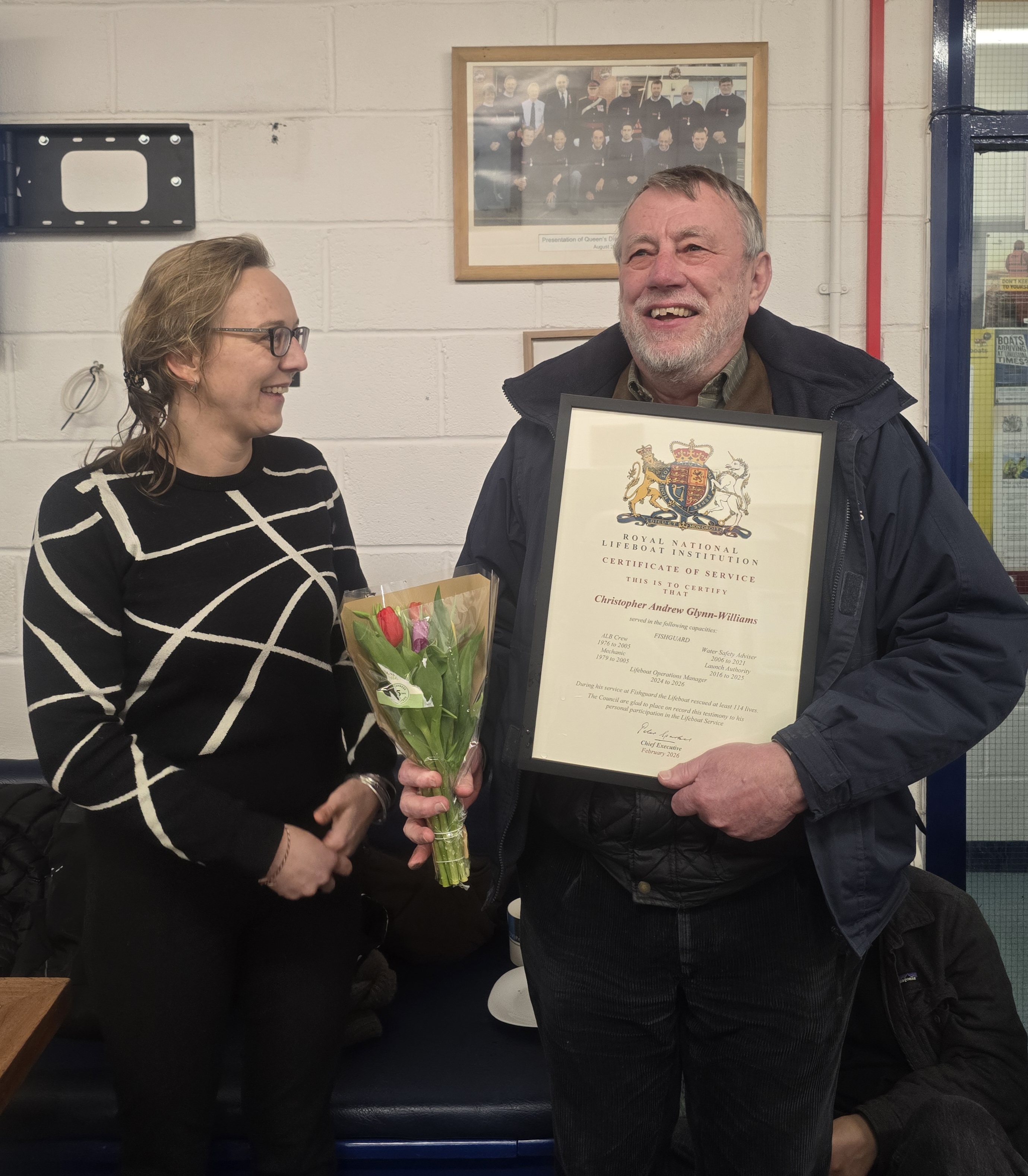 Volunteer Lifeboat Operations Manager Chris Williams being presented with his certificate of service by RNLI full time Area Operations Manager Ewa Crabtree.