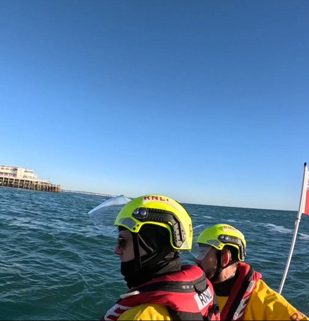 Two d-class crew members looking for casualty in the water.