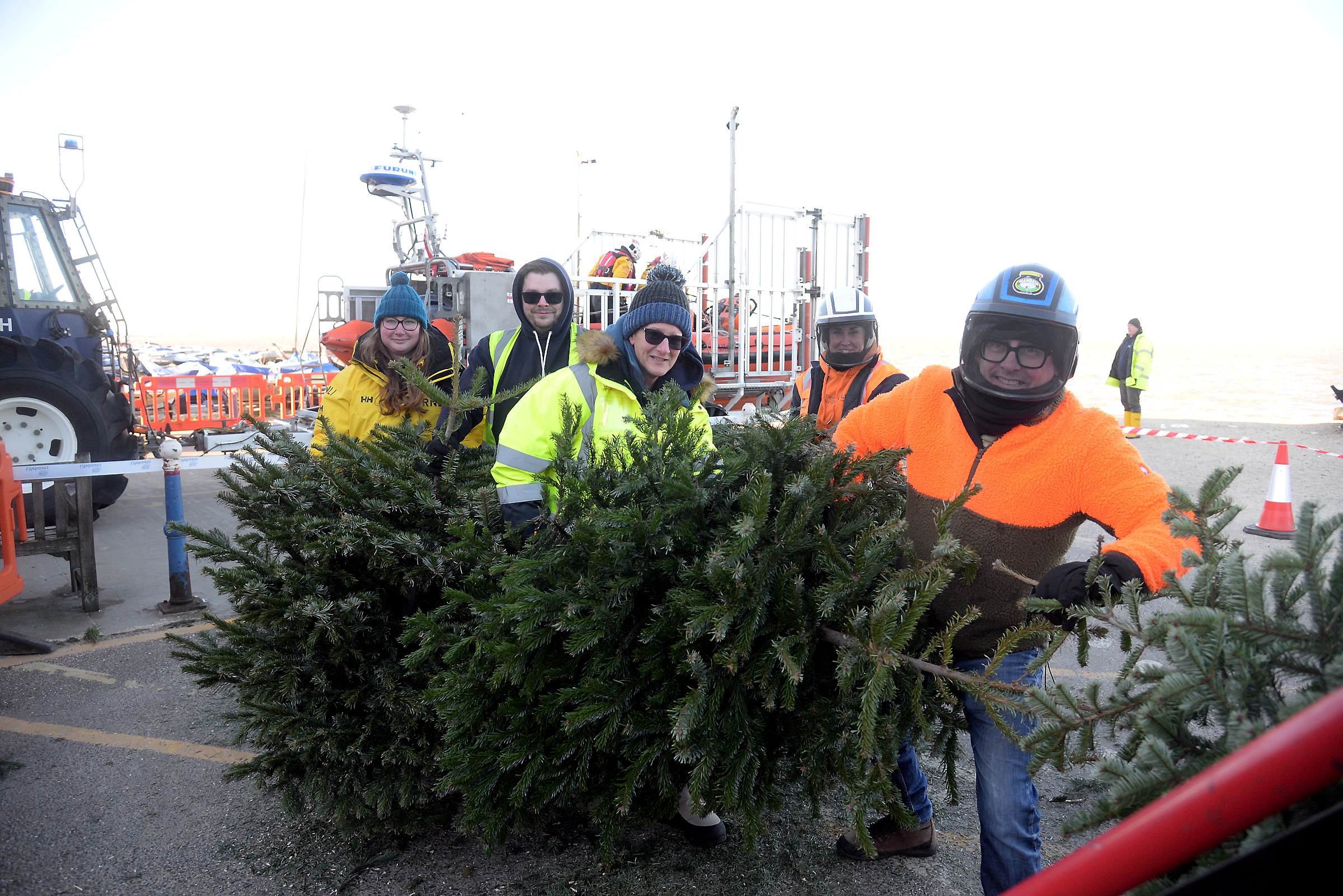 Christmas trees enter the 'chipper' at Whitstable RNLI on Sunday.