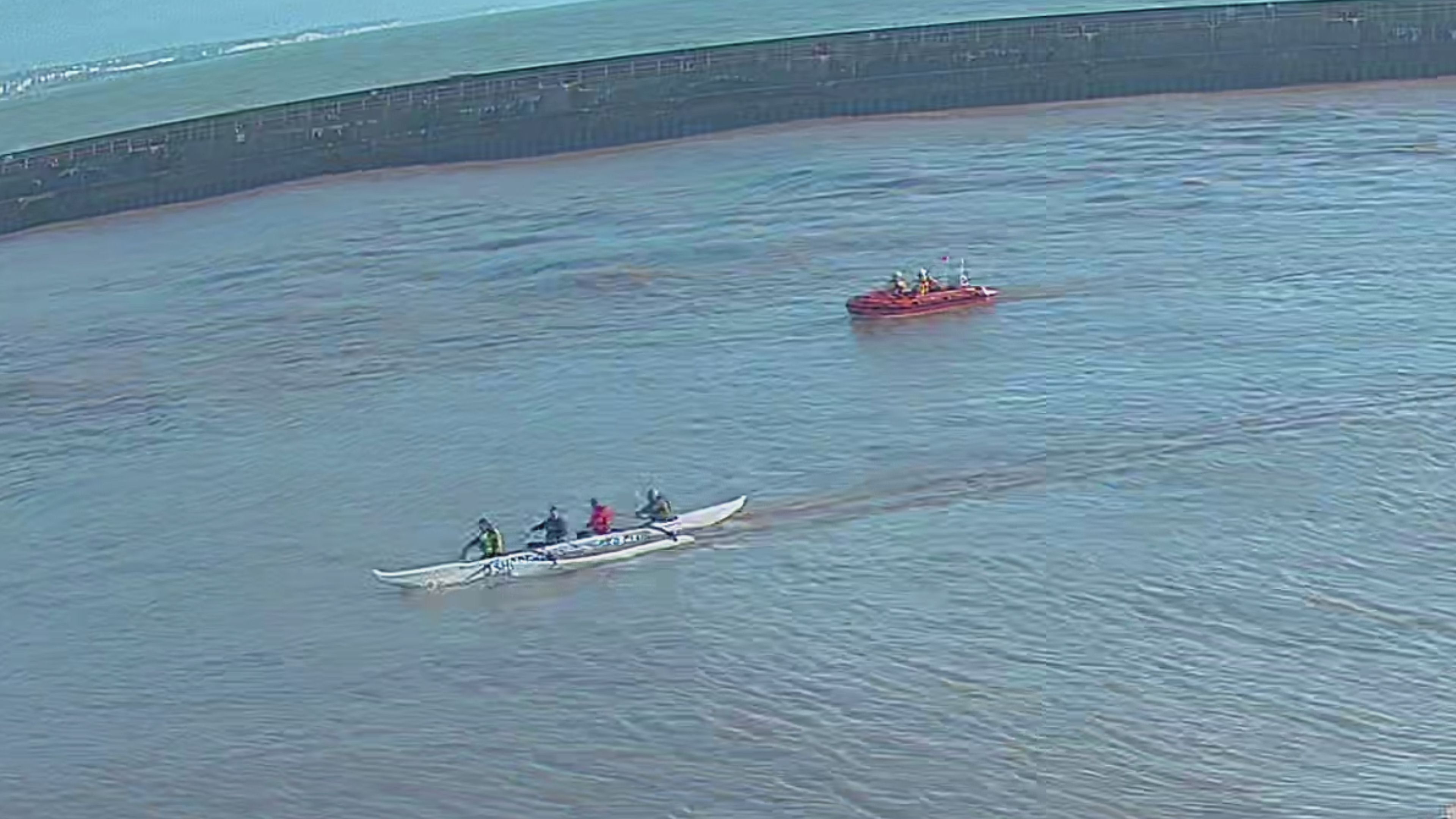 Four outriggers now in control of their boat, being escorted to safety by Shoreham RNLI.
