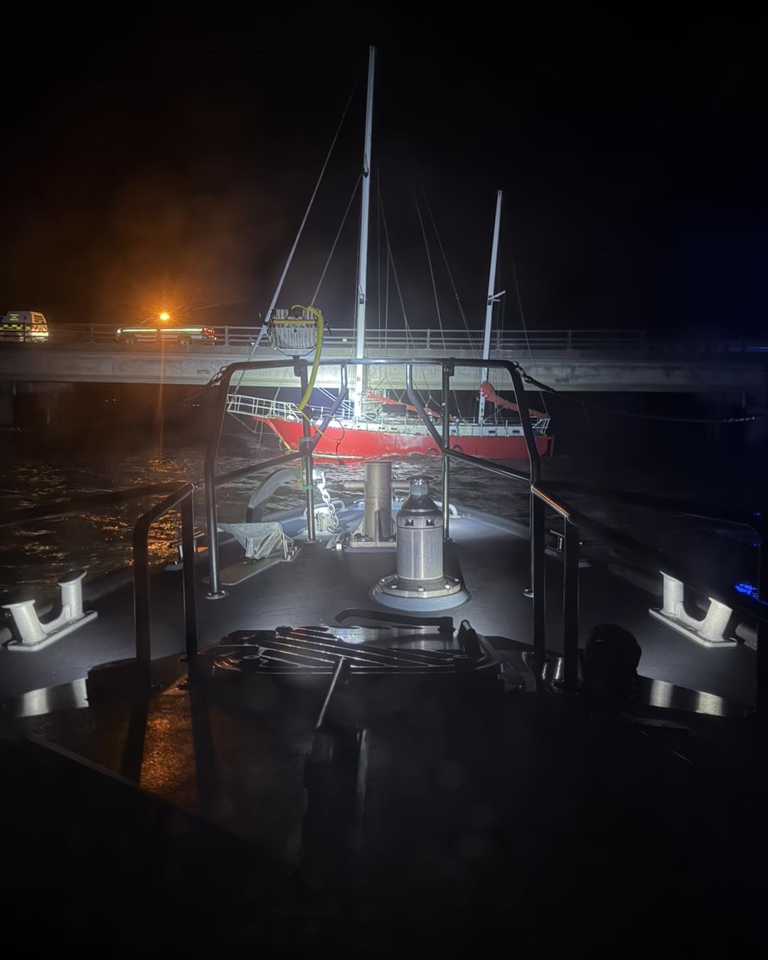 Invergordon Lifeboat monitoring yacht against Cromarty Bridge