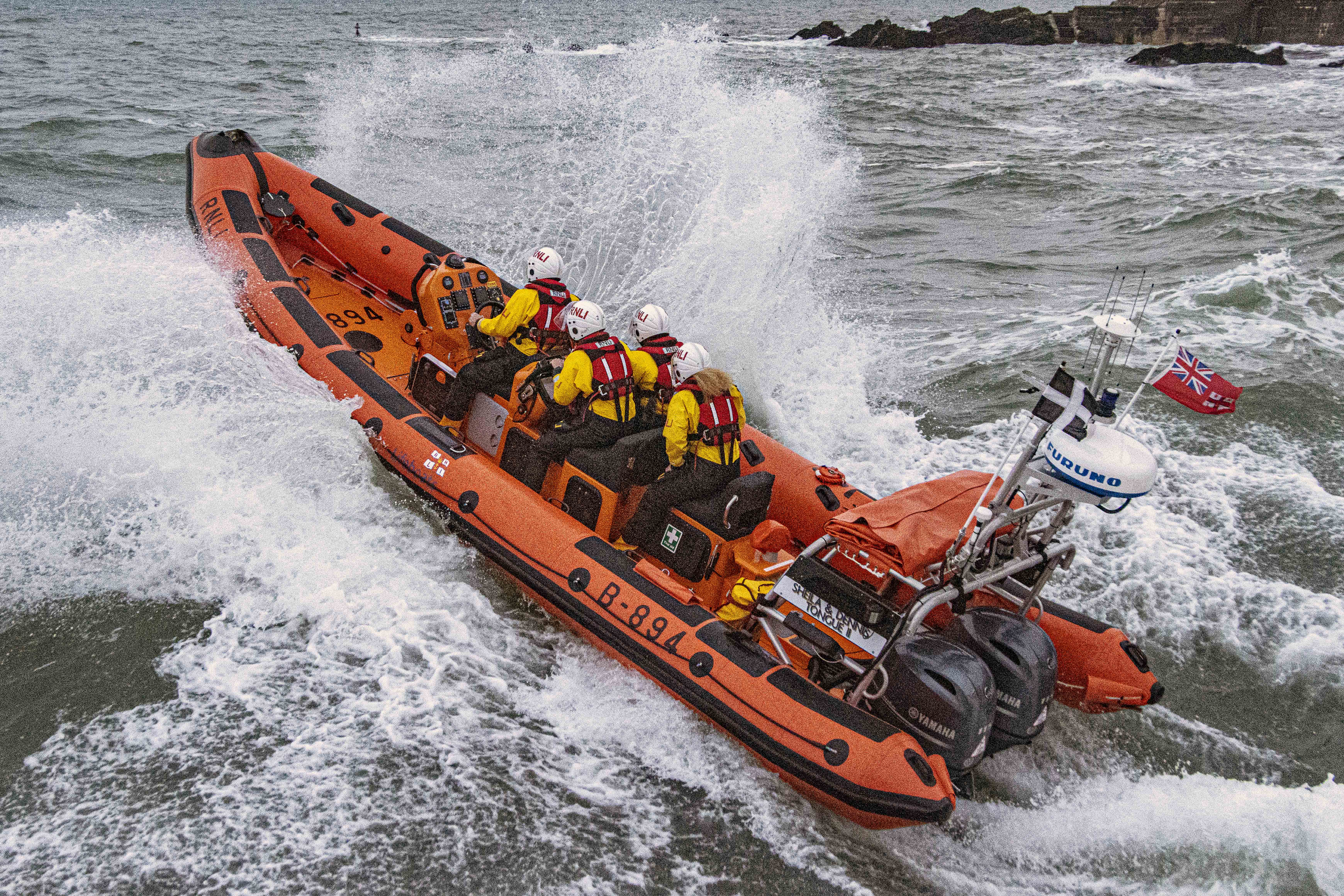 Stock image - Looe RNLI Atlantic 85 Sheila and Dennis Tongue II leaving Looe negotiating heavy seas
