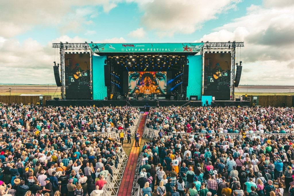 A music venue with stage and crowd watching a performance