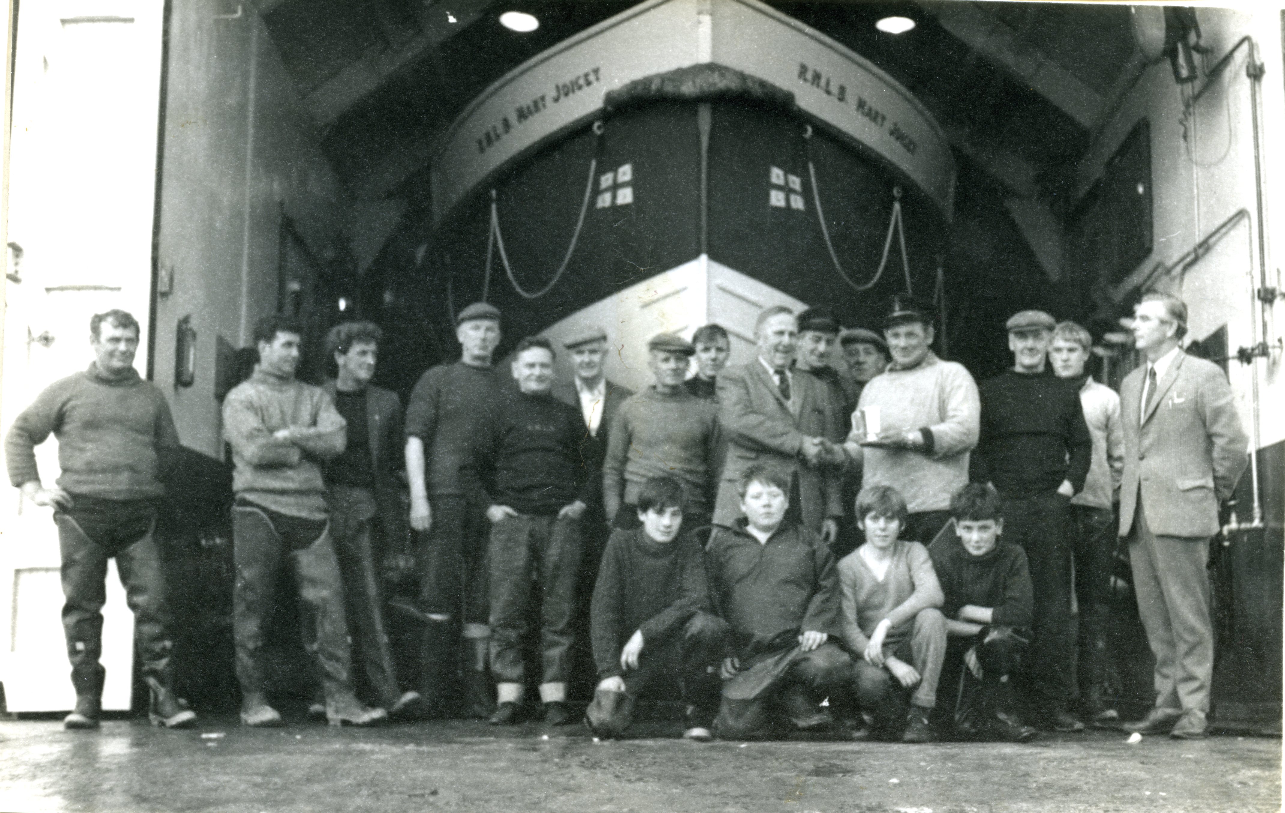 Group photograph in front of boathouse