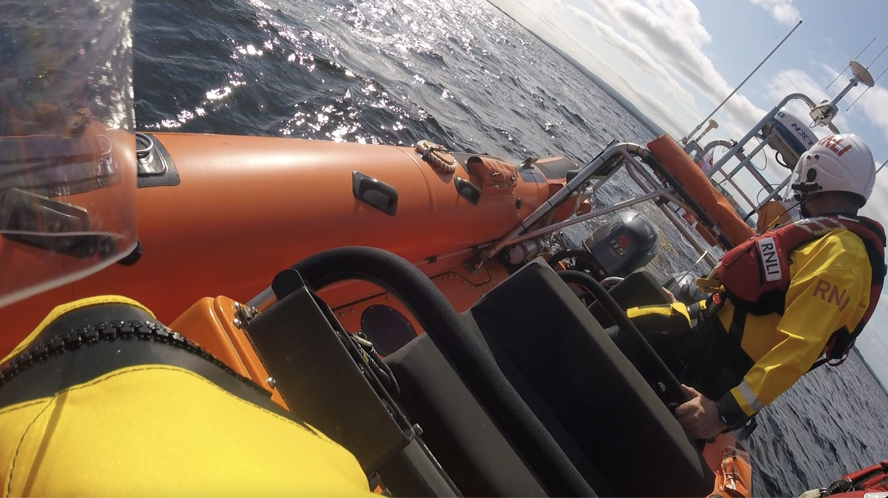 View from the helm seat looking back the lifeboat and at the crew monitoring the tow