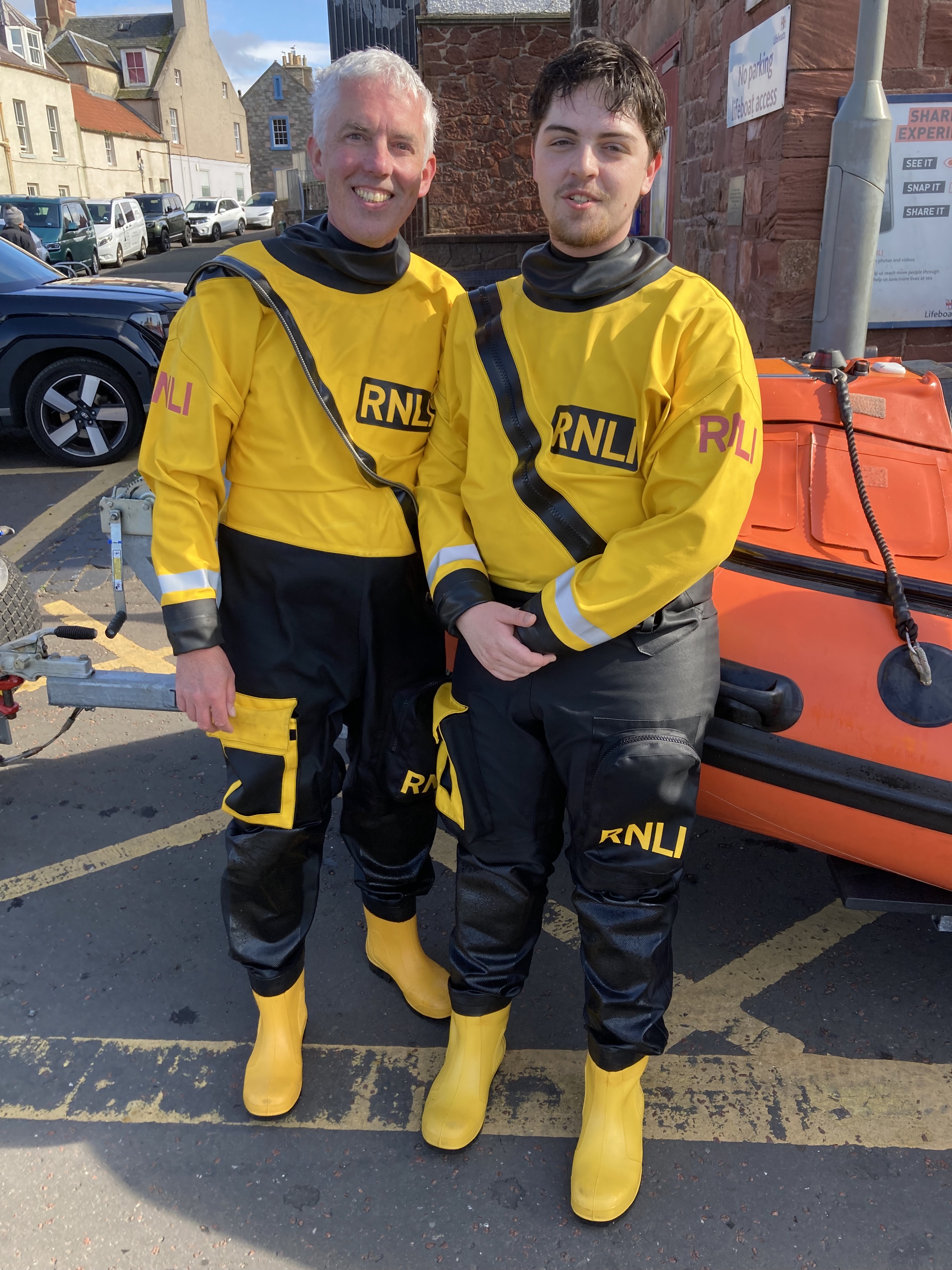 Two men in lifeboat gear.