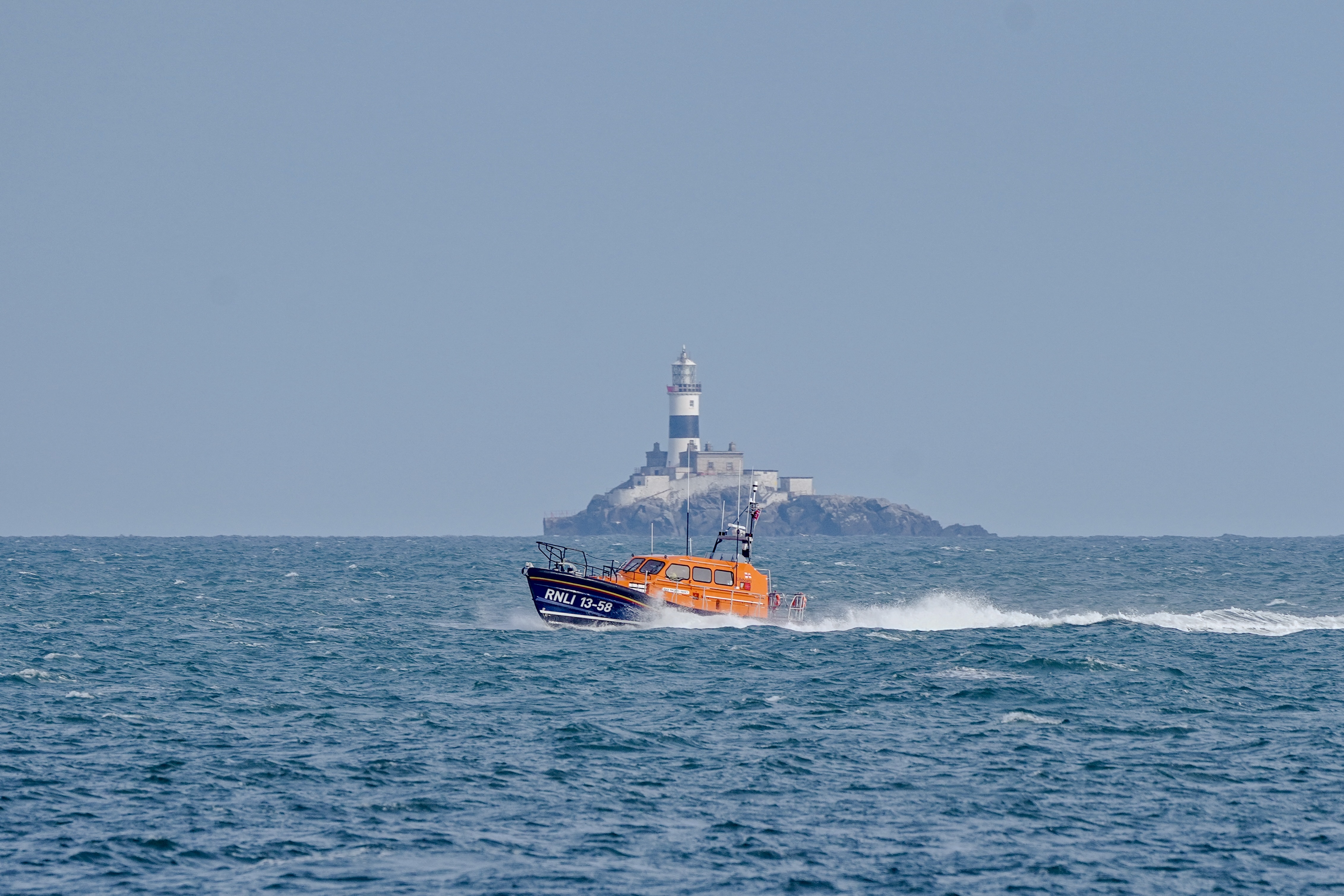 Larne's Shannon class all-weather lifeboat Machiko Nancy sailing past the front of the East Maidens Lighthouse