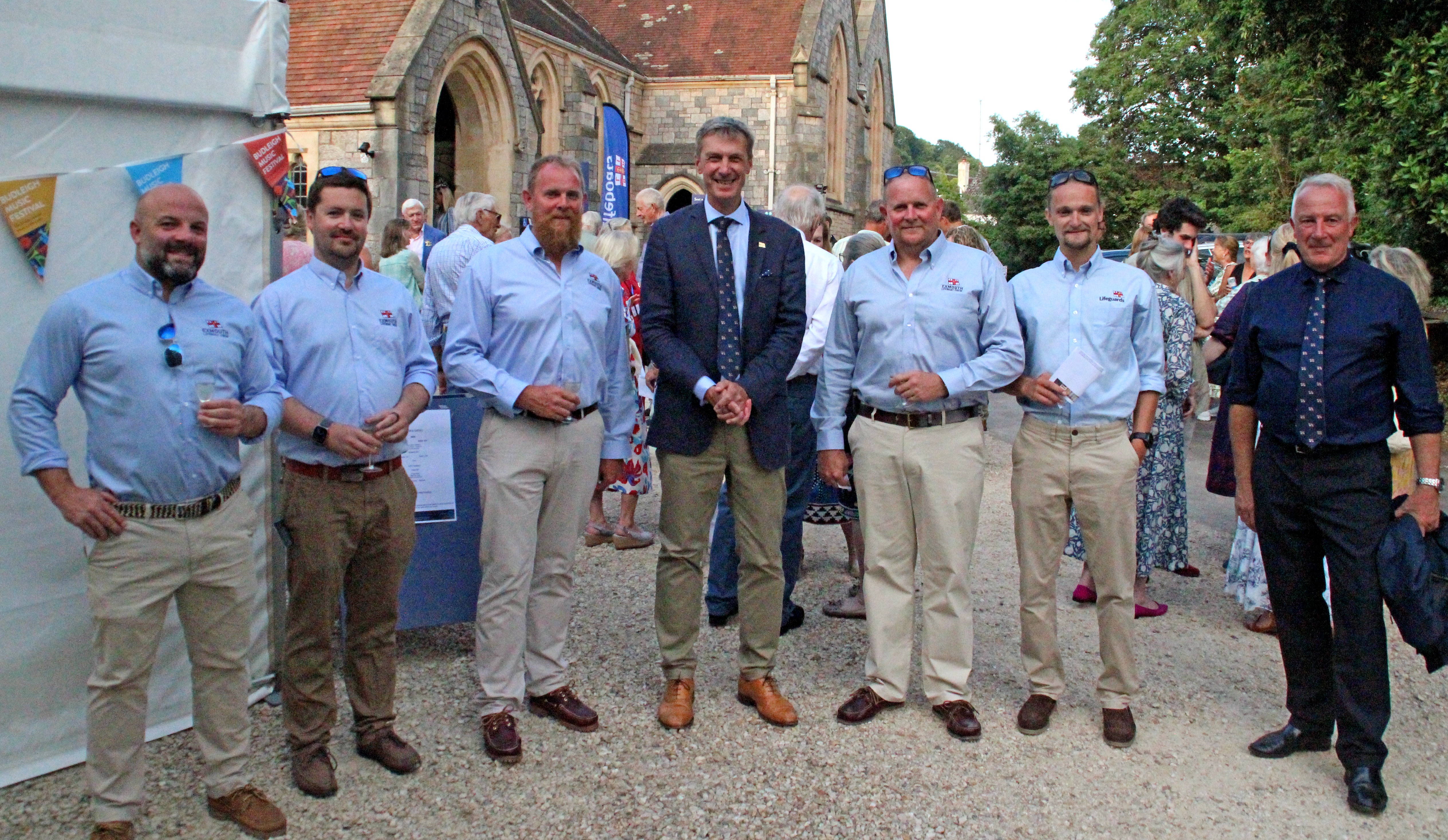 RNLI Charity CEO Peter Sparkes alongside Exmouth RNLI crew members at Budleigh Music Festival RNLI benefit concert, held at St Peter's Church