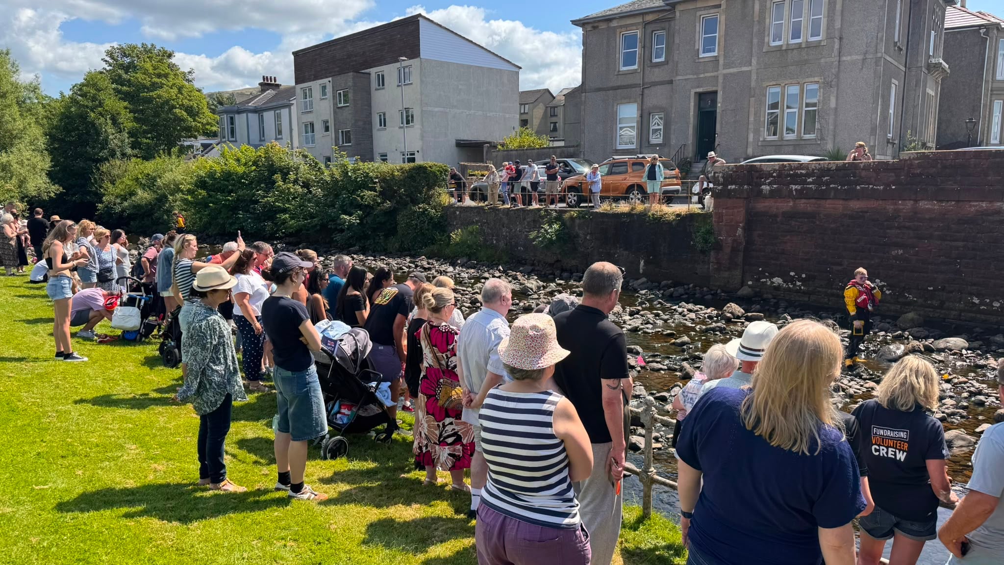 Crowds line the banks to watch for the winner