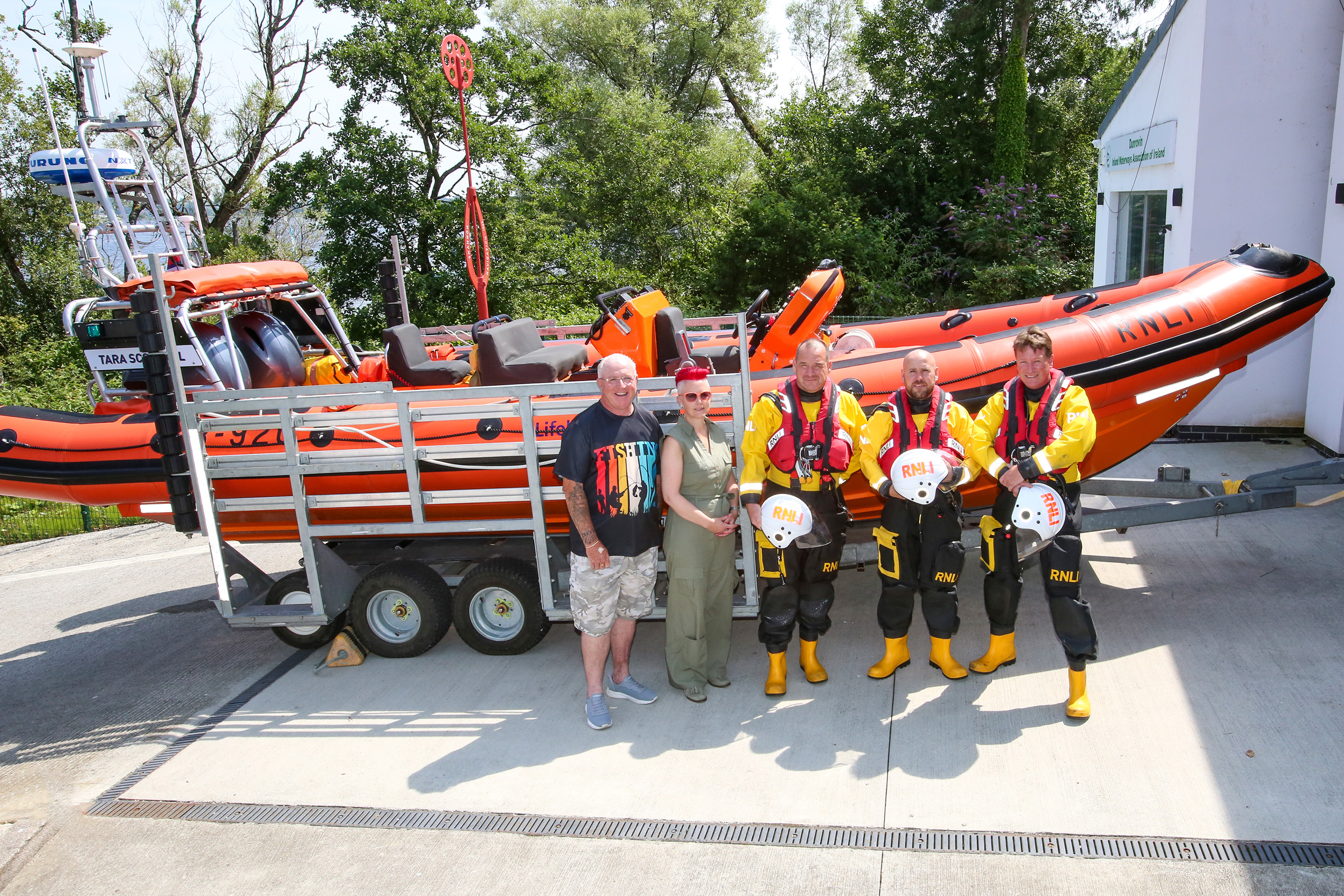 John and Lynda pictured at Lough Ree RNLI with the lifeboat and crew on the water in background