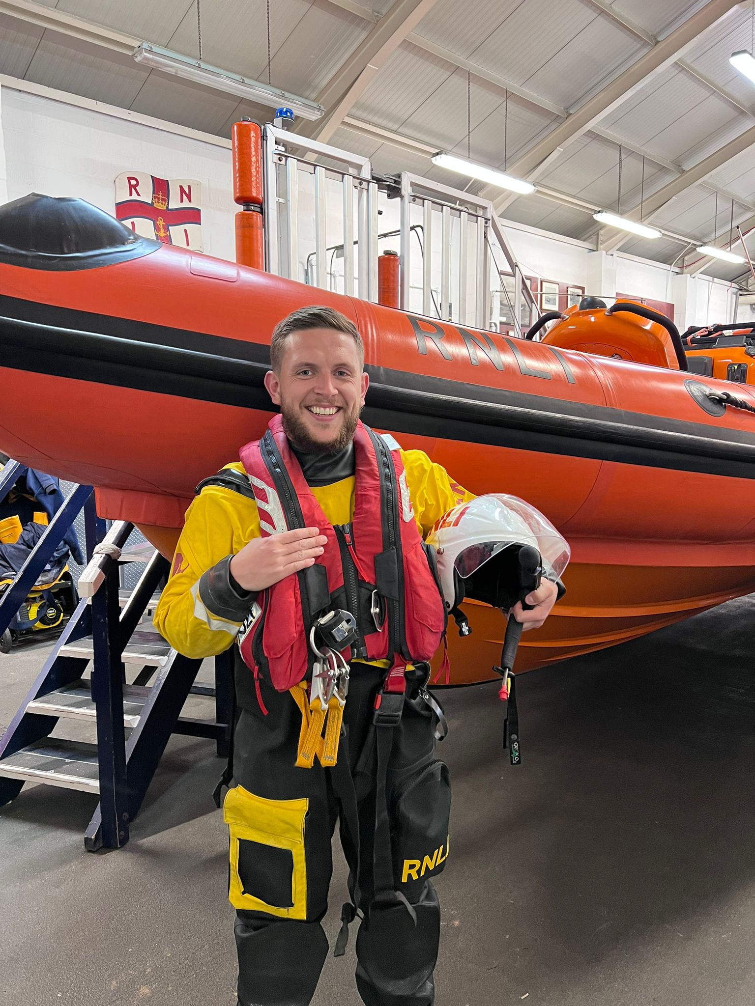 New helm Connor stood next to New Brightons Atlantic 85 Lifeboat