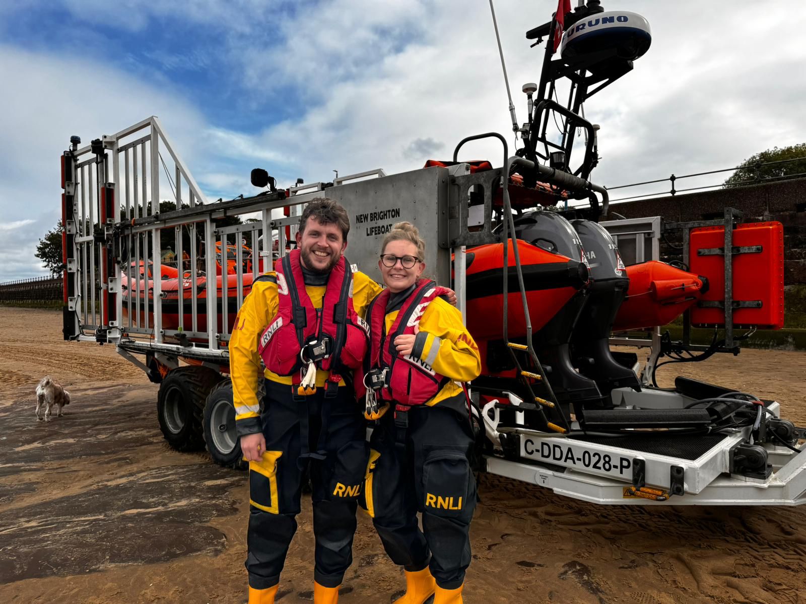 Connor and his partner Ffion stood next to the Atlantic 85 Lifeboat