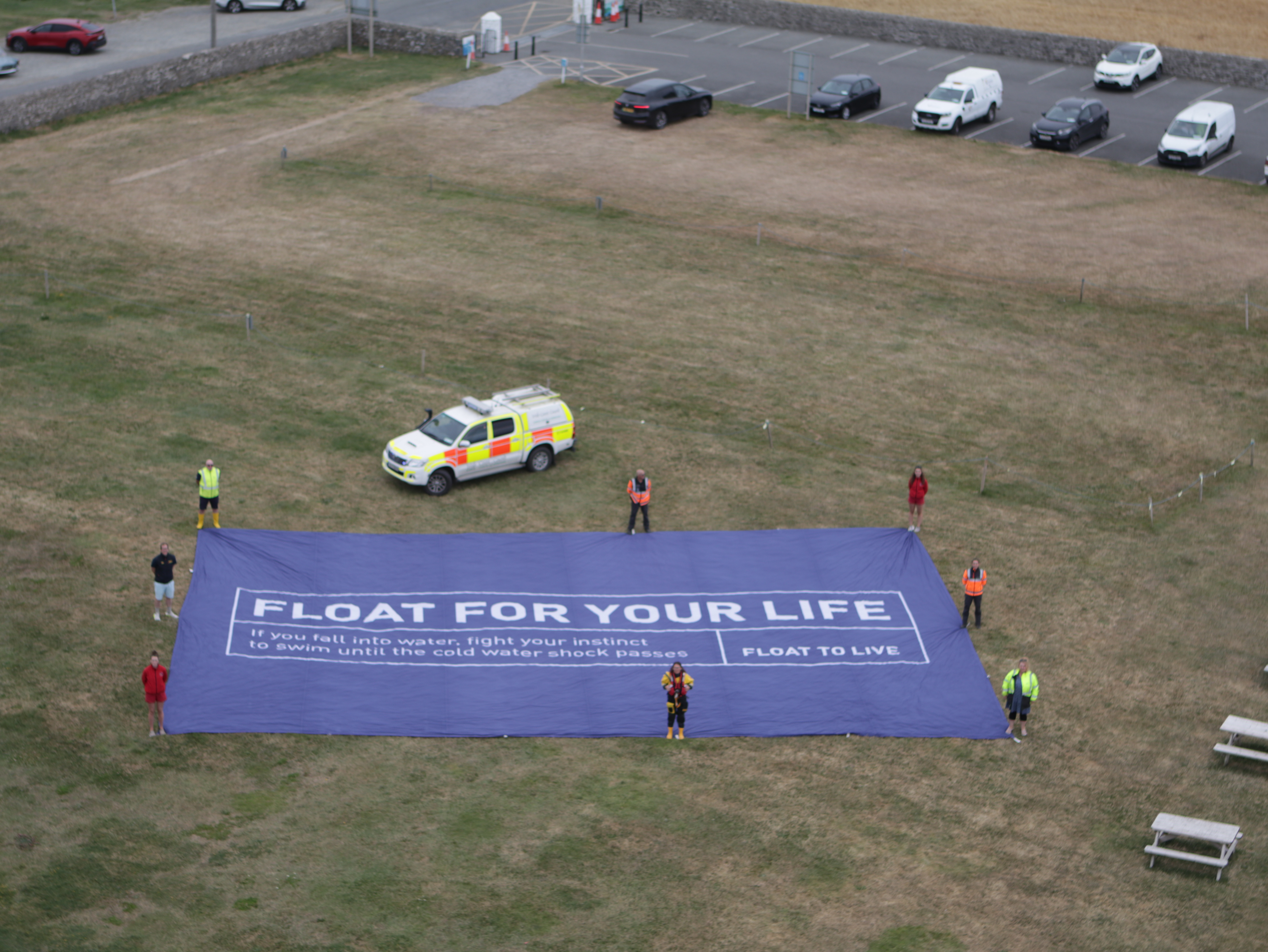 Members of the Irish Coast Guard, RNLI and Water Safety Ireland unite to turn the tide at Hook Head with a Float for your life flag