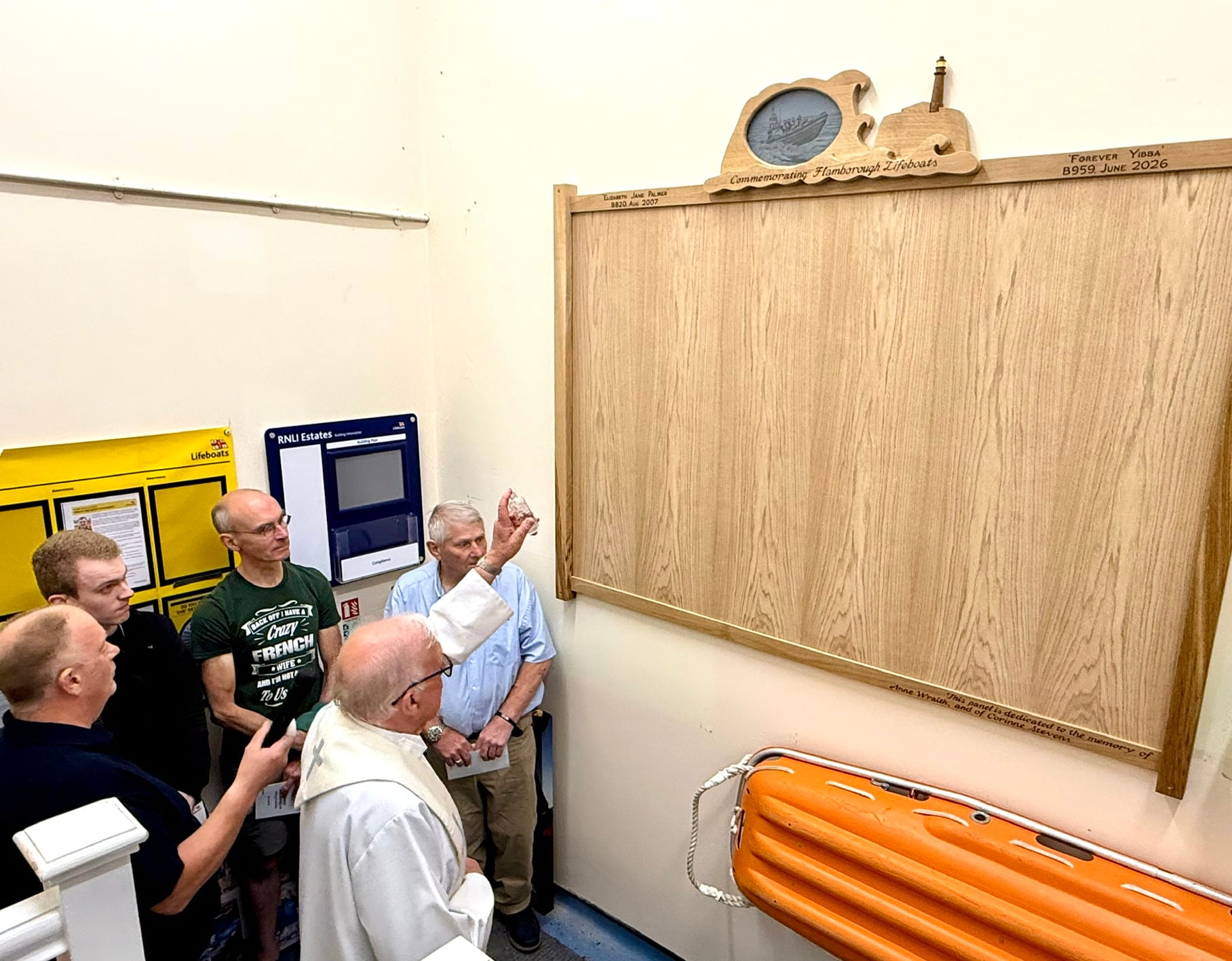 Chaplain Father Wilson blessing the new memorial board
