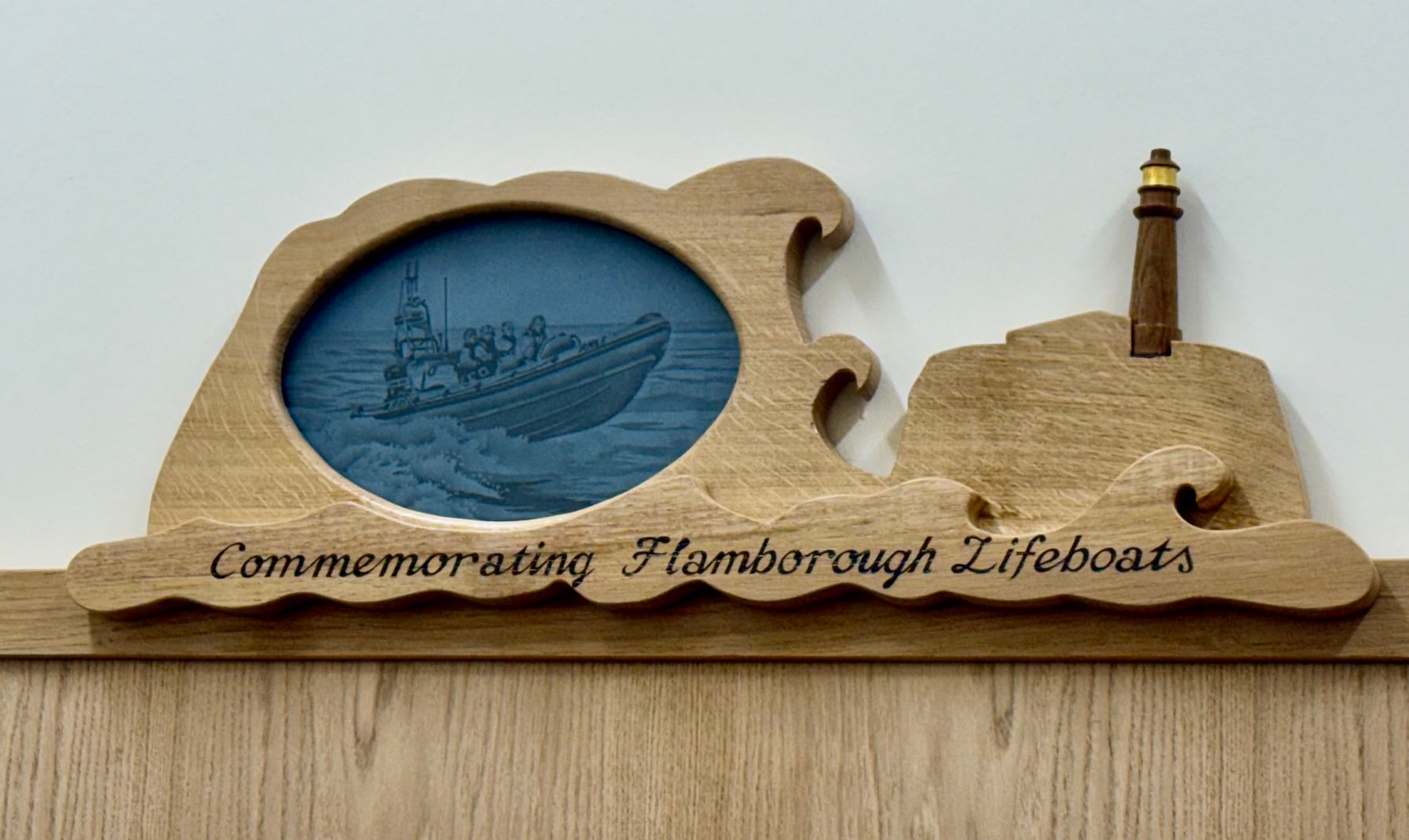 close up of the etched glass with a atlantic 85 and a carved lighthouse