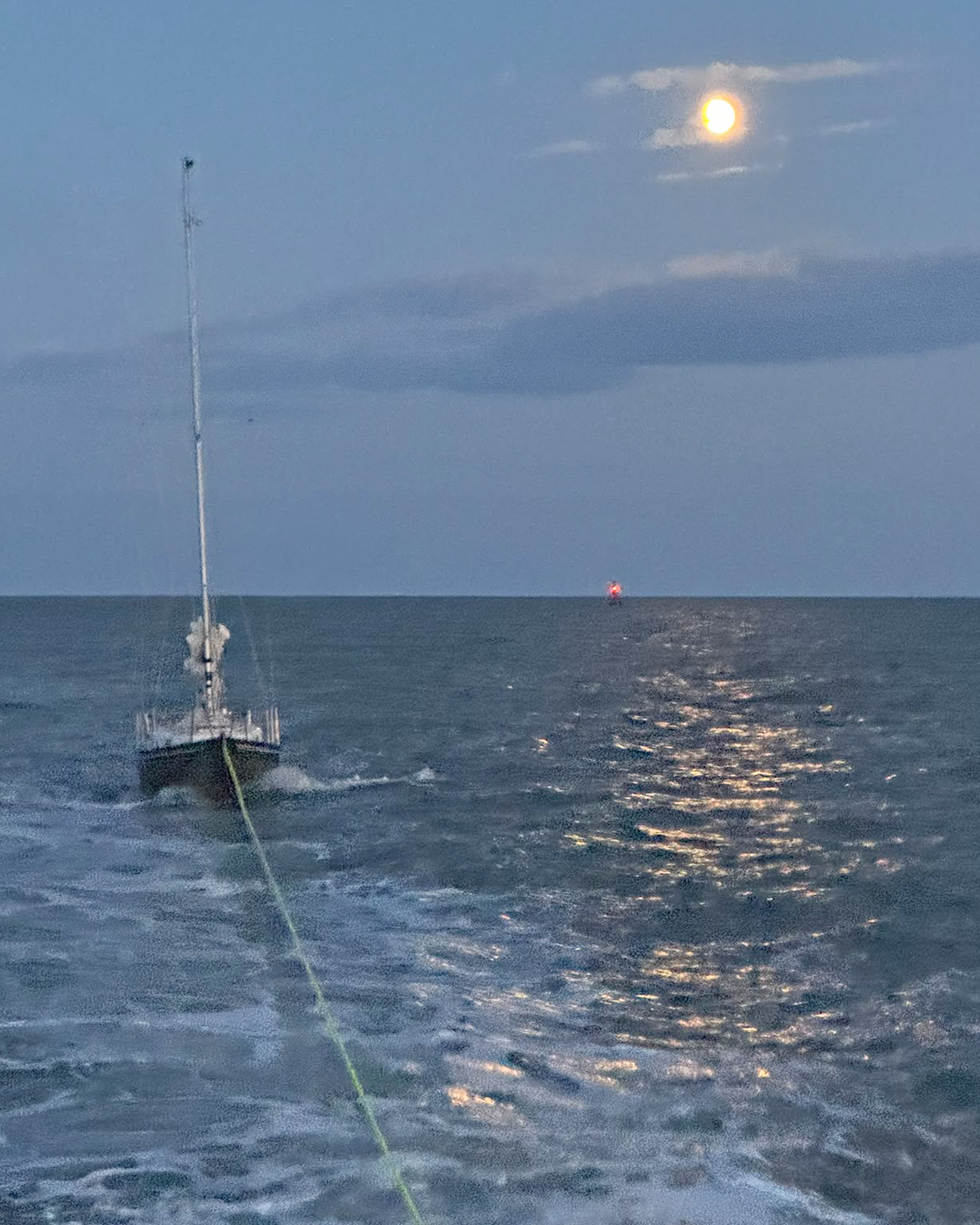 Lowestoft RNLI lifeboat towing the yacht in the moonlight
