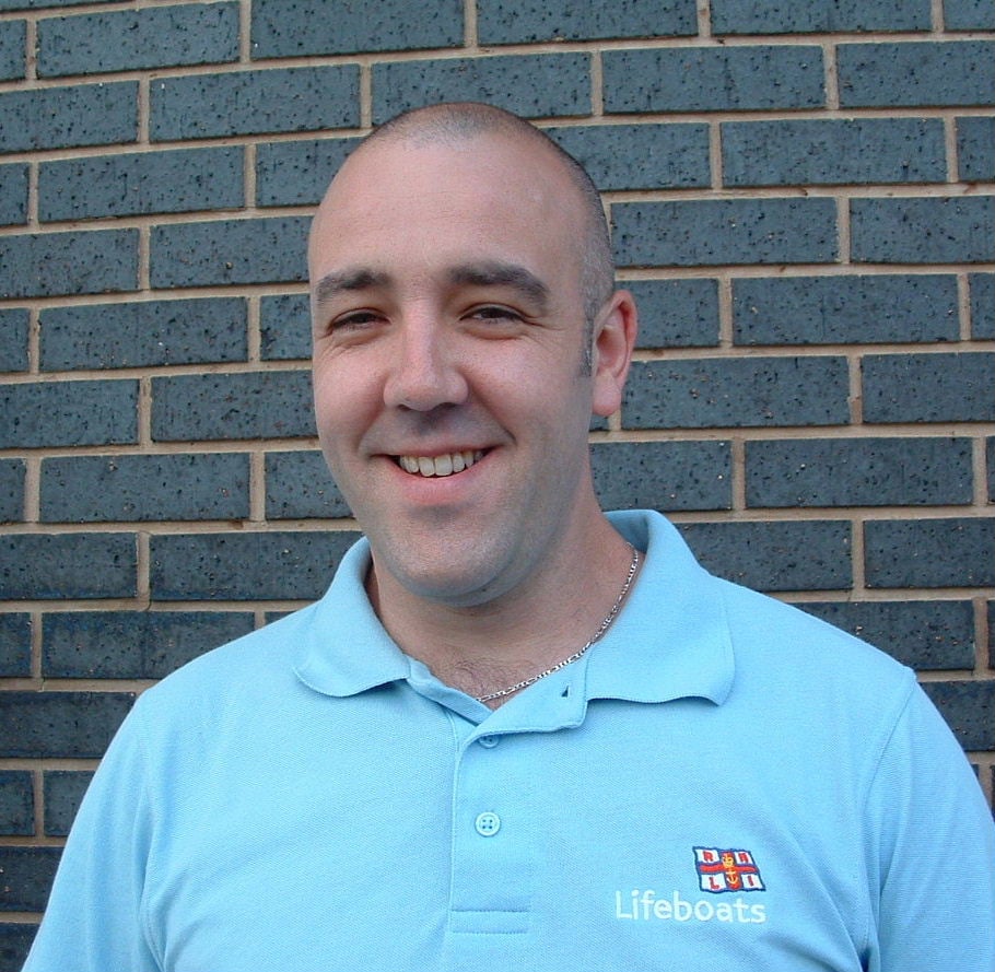 a man smiles at the camera