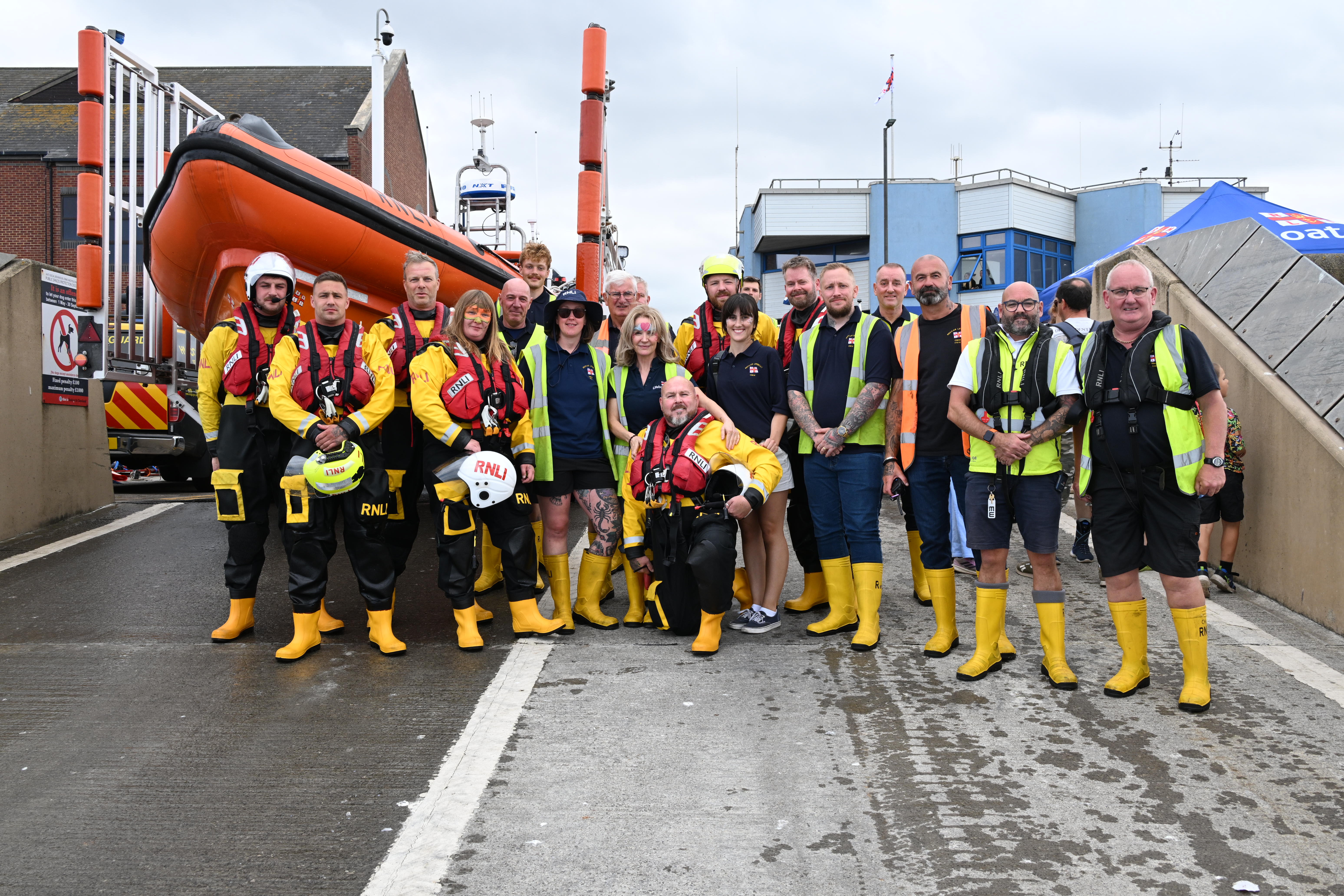 Crew gather in front of the lifeboats after the Flag Day display