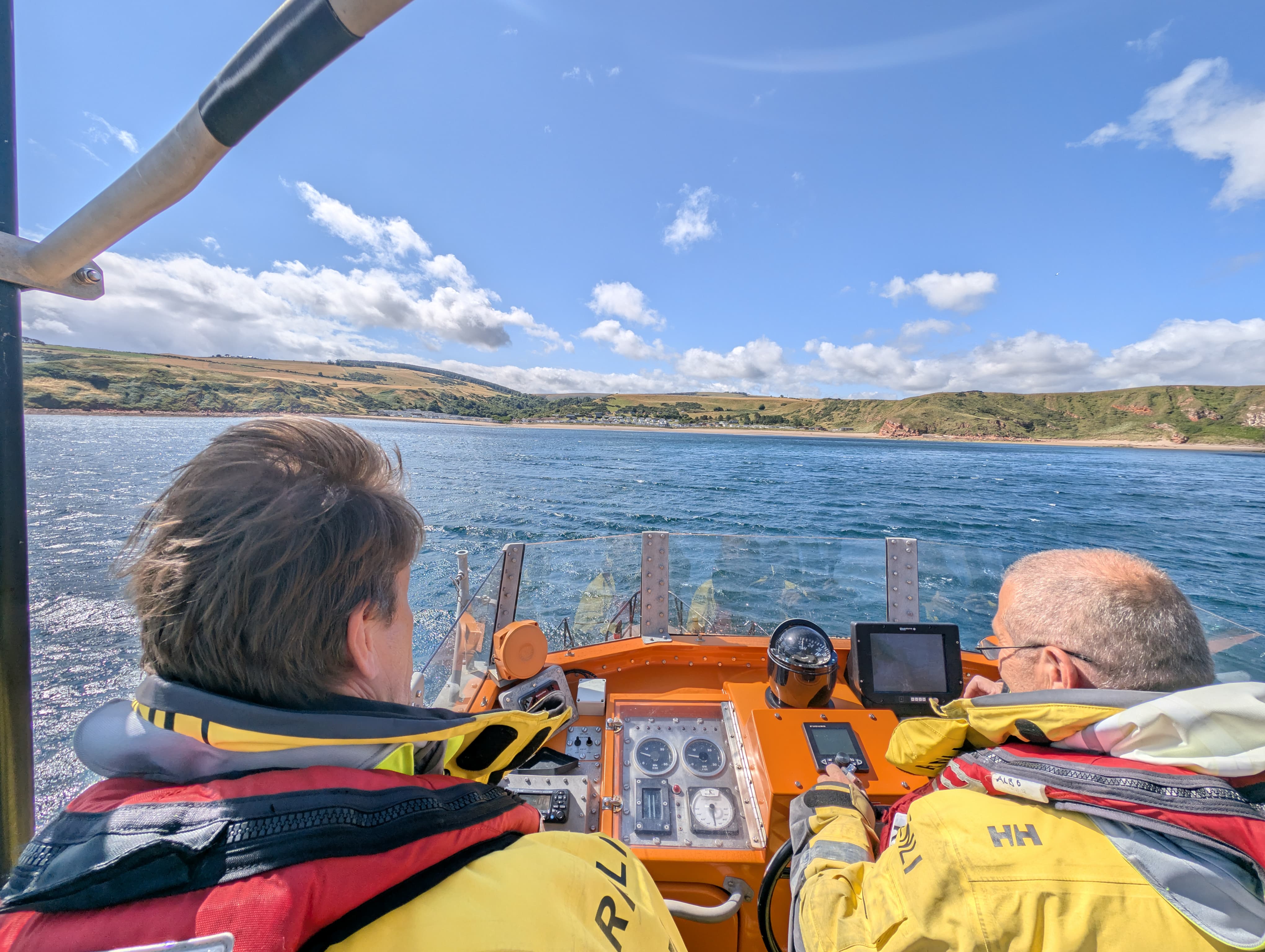 Two men on lifeboat.