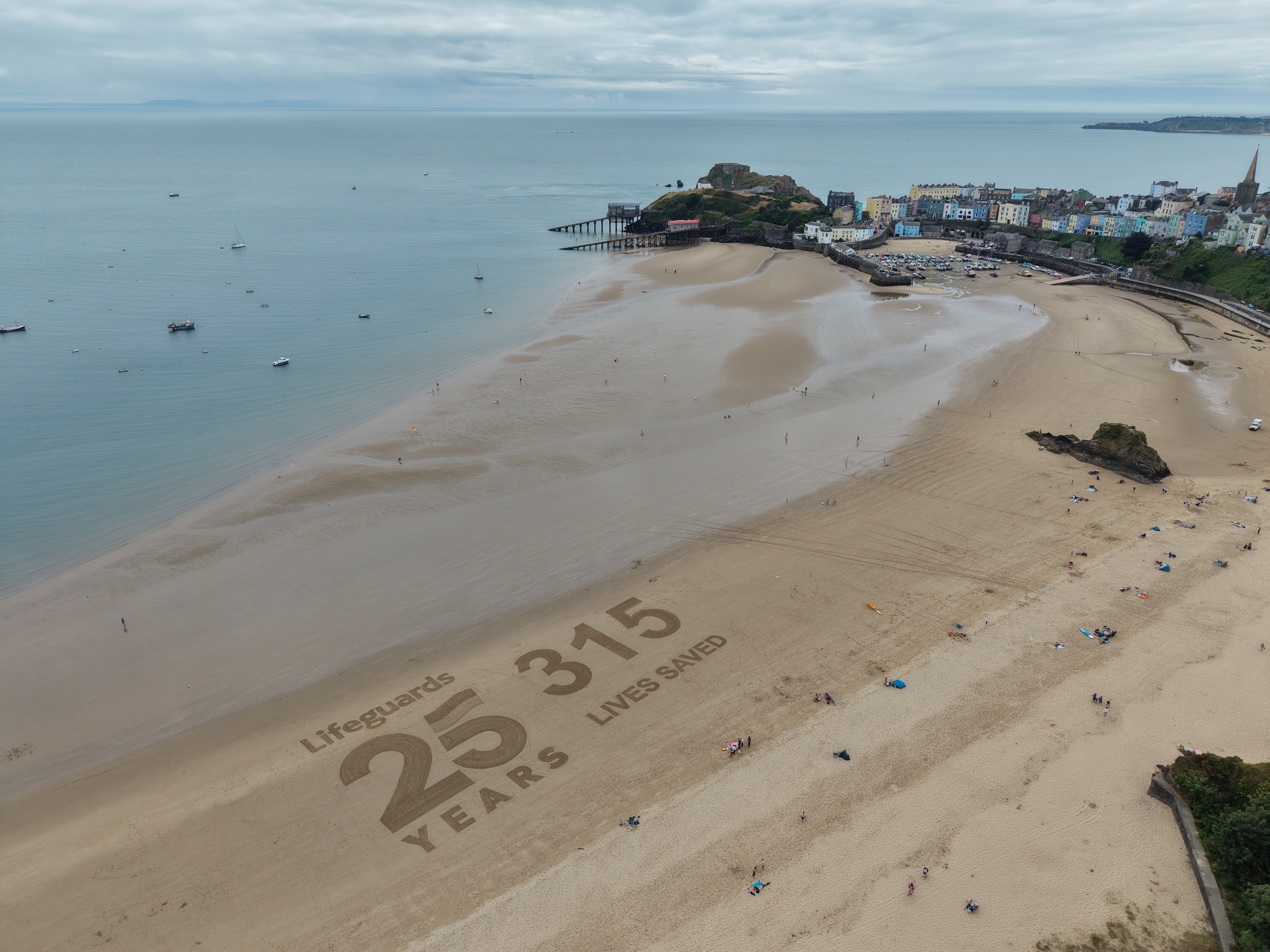 Sand art on Tenby North Beach 