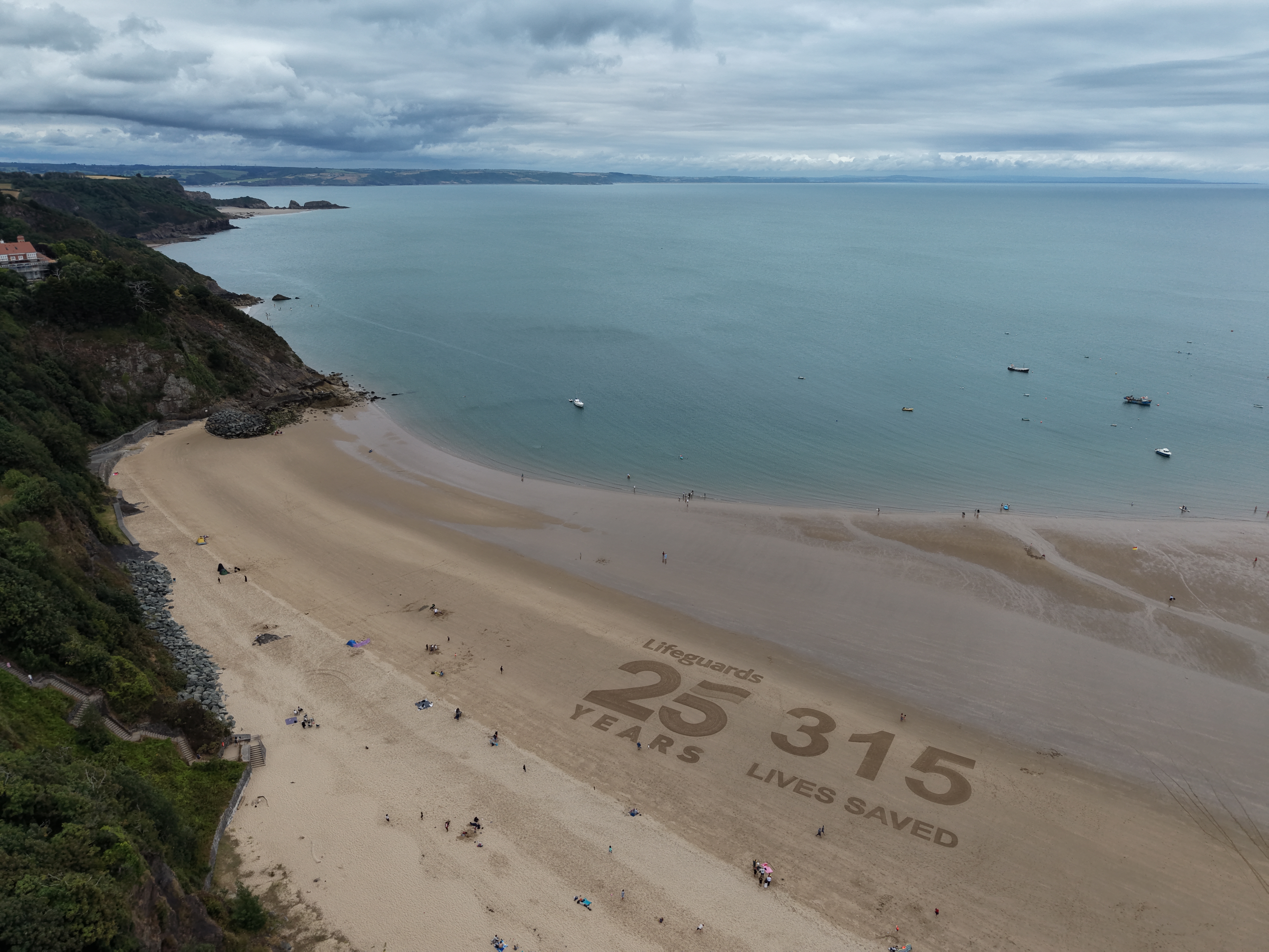 Sand art on Tenby North Beach 