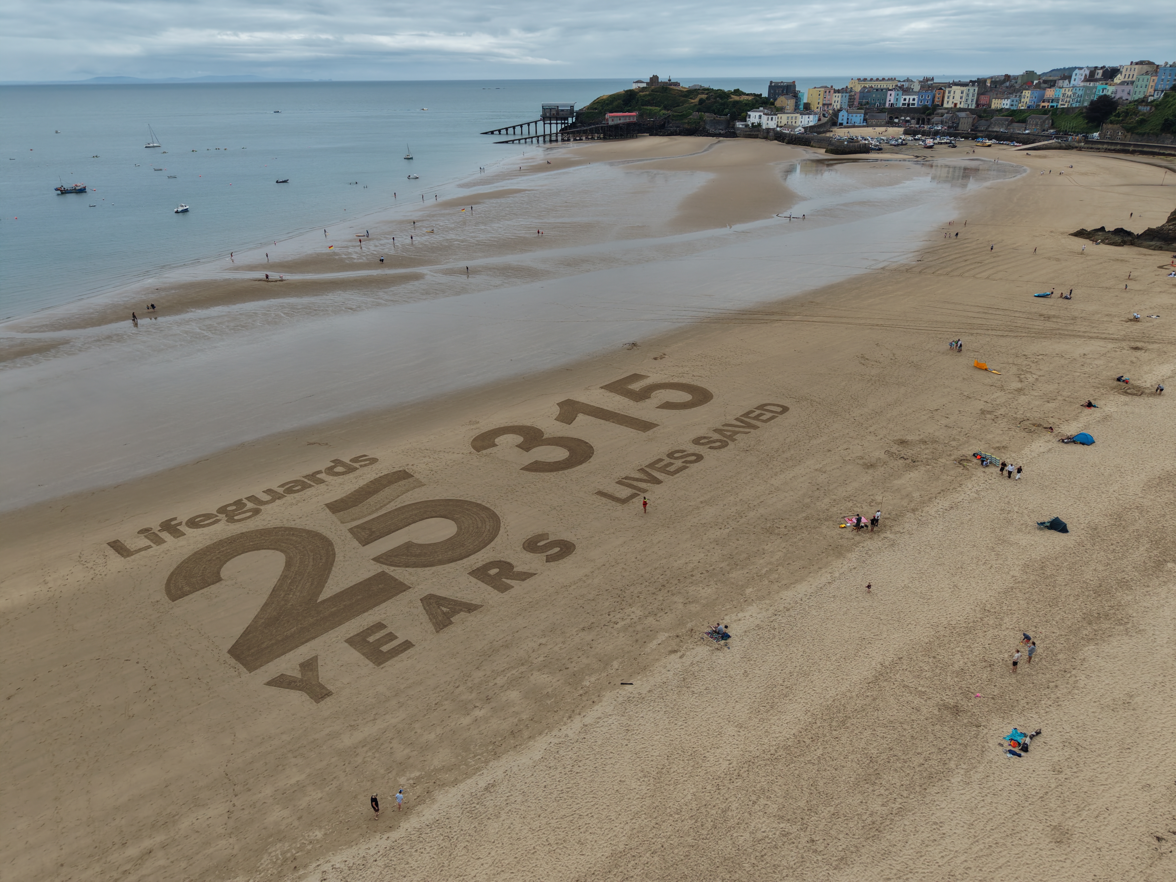 Sand art on Tenby North Beach 