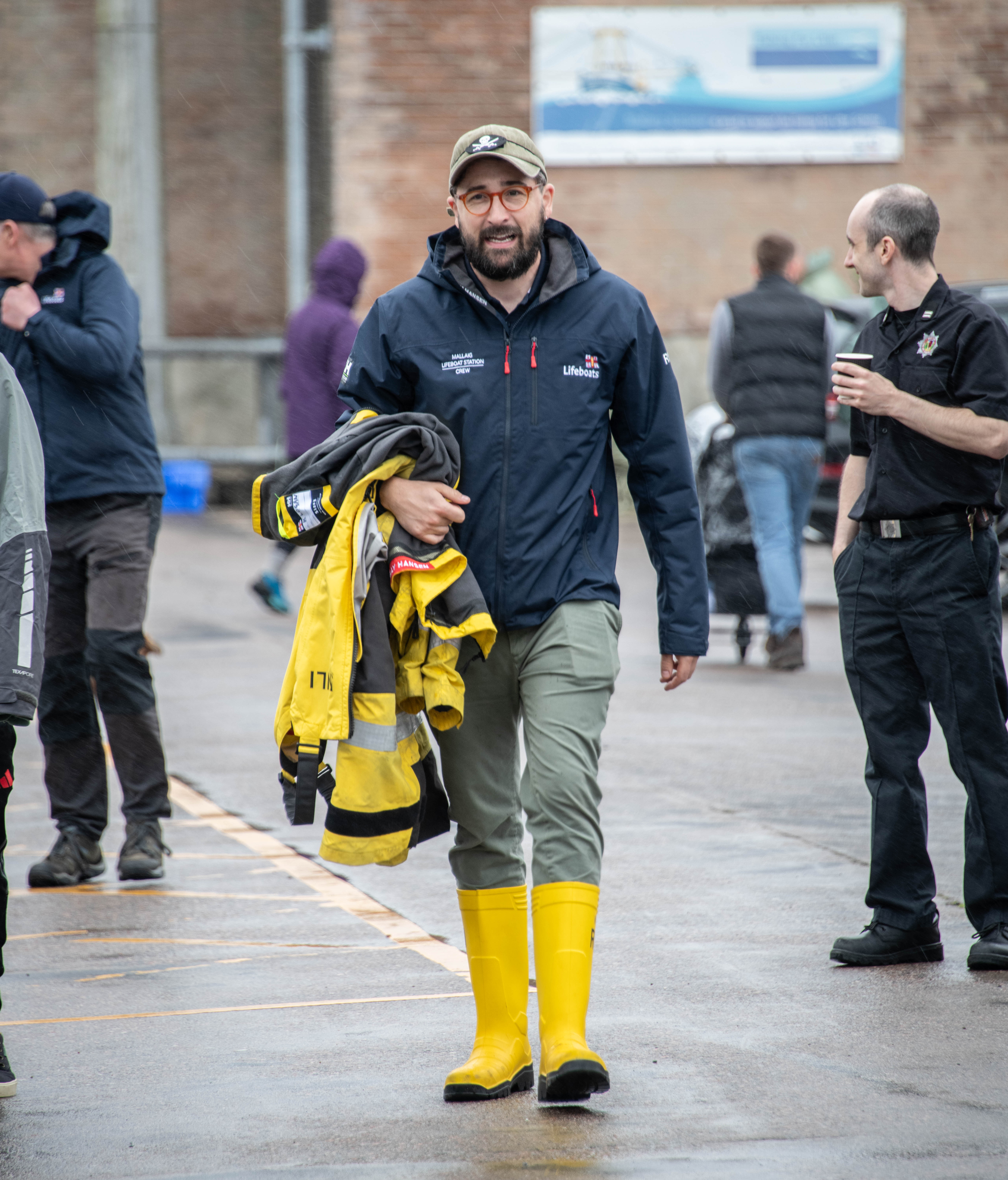 RNLI Mallaig crew member heads away from Gala Day to shout