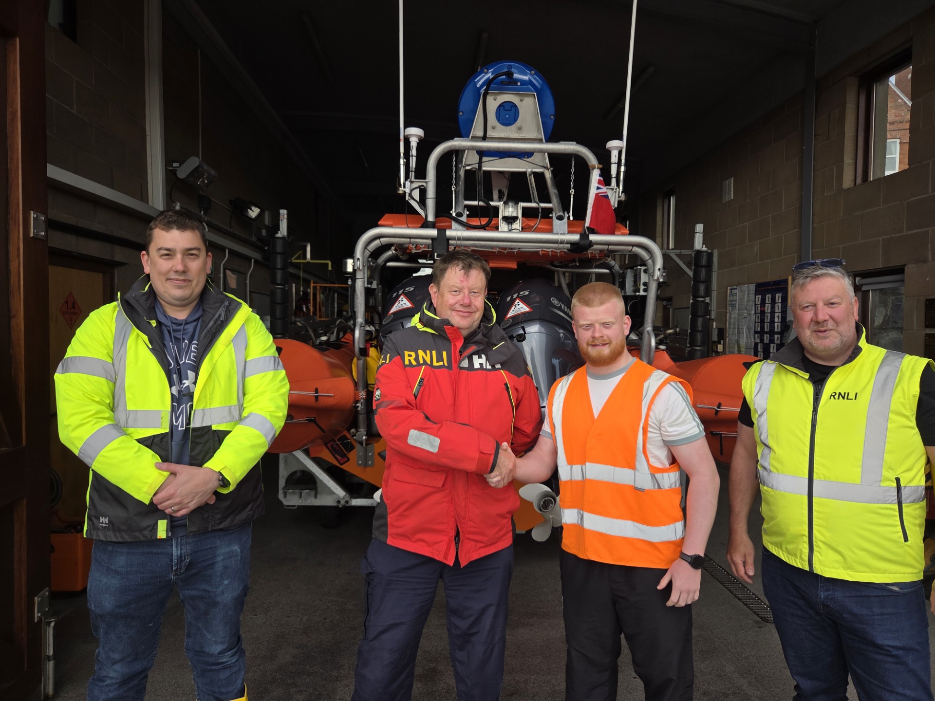 Mark Mitchell congratulates RNLI volunteers