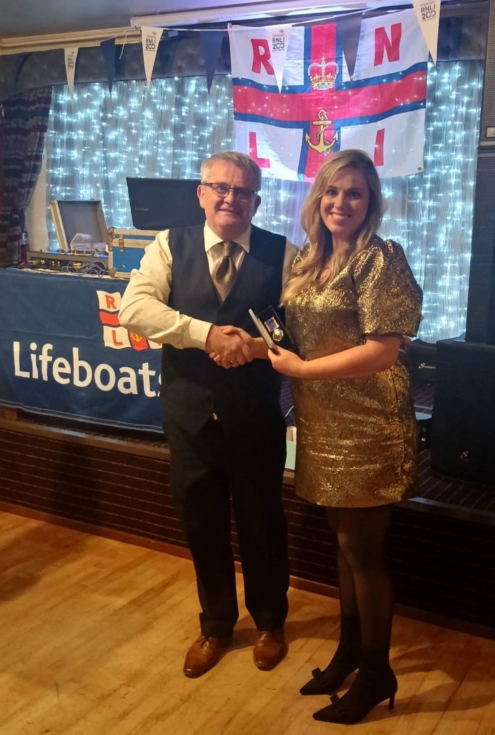 Amy Mc Carter receiving her 20 Year Service Badge from Paddy Murphy