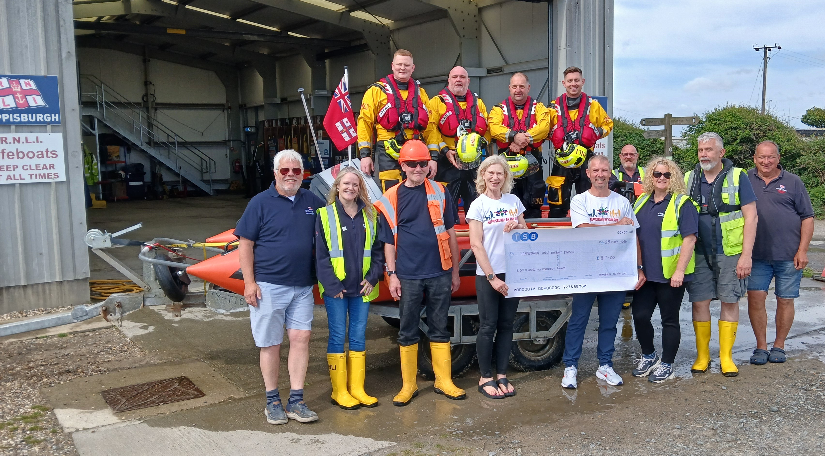 Steven and Sonya handing over the cheque at Station
