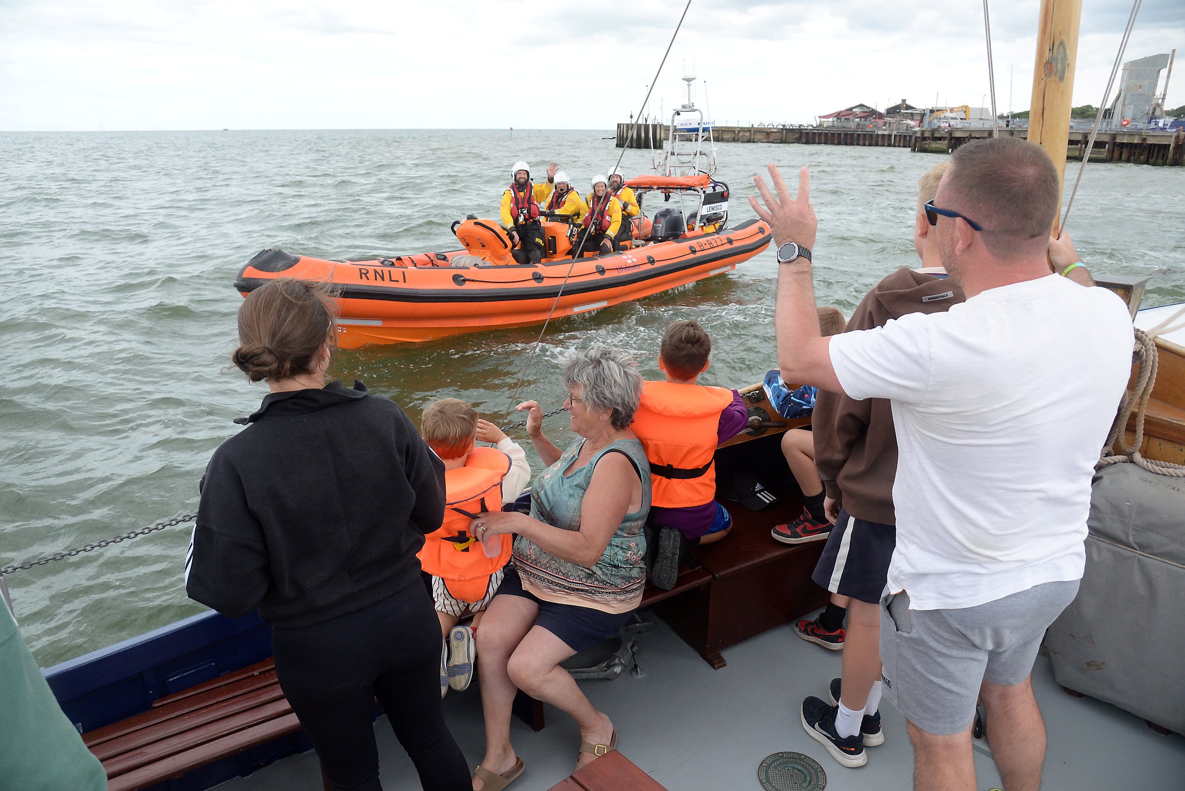 Whitstable's B-Class lifeboat Lewisco passes alongside relatives of Miss Connie Lewis whose bequest funded the lifeboat onbard the former RNLI lifeboat The Chieftain off Whitstable on Sunday.