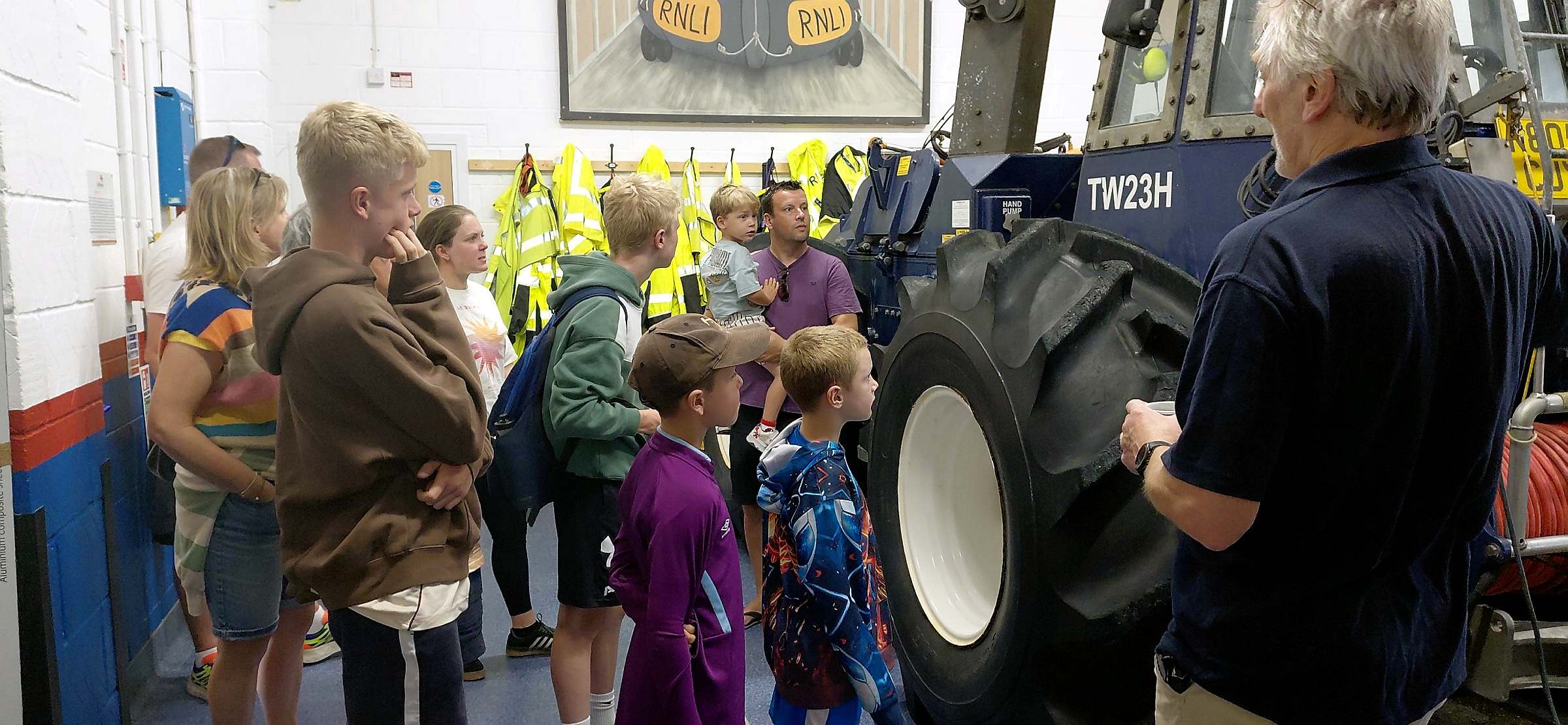 Members of Lewisco are shown around the lifeboat station by Helm Dave Parry.