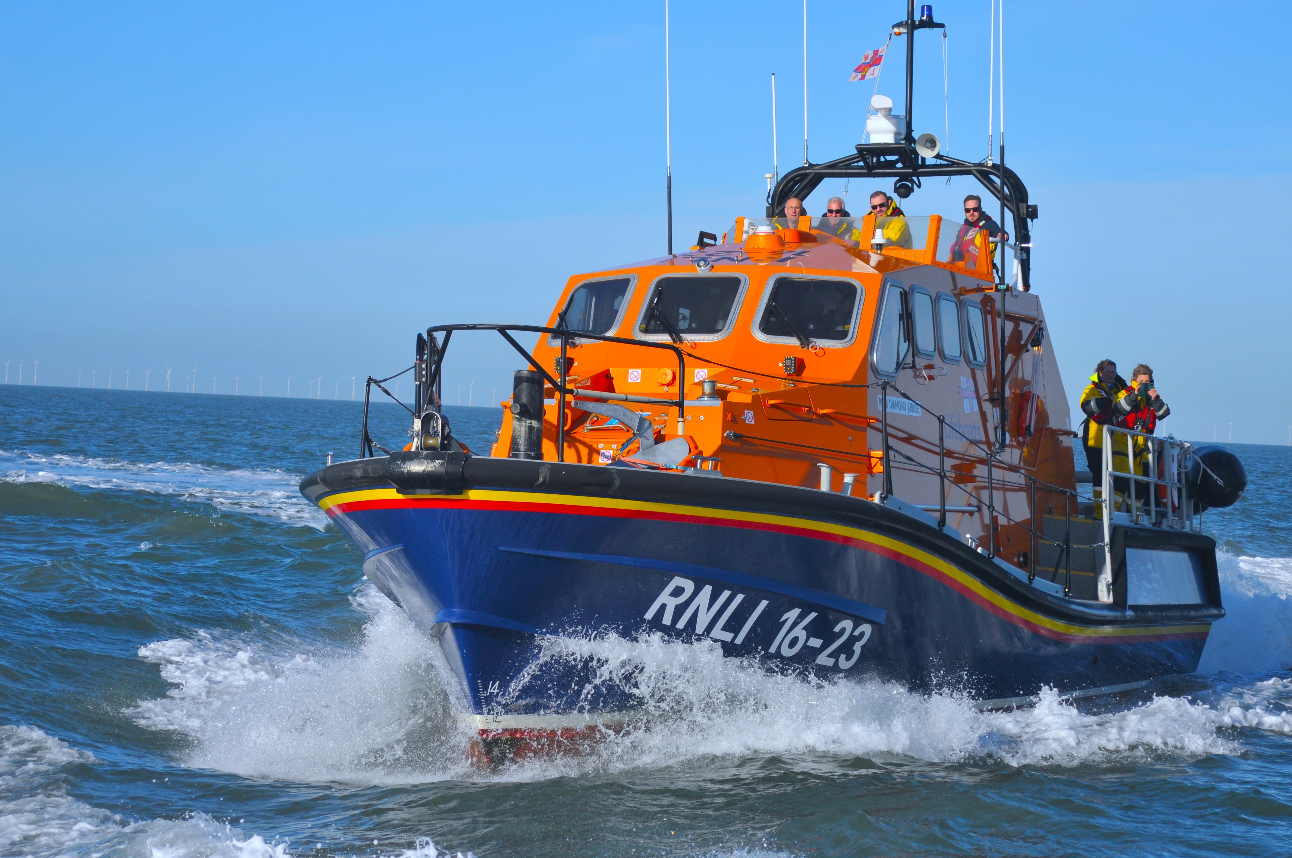 Ramsgate RNLI lifeboat 16-23 on open water with crew members standing on deck