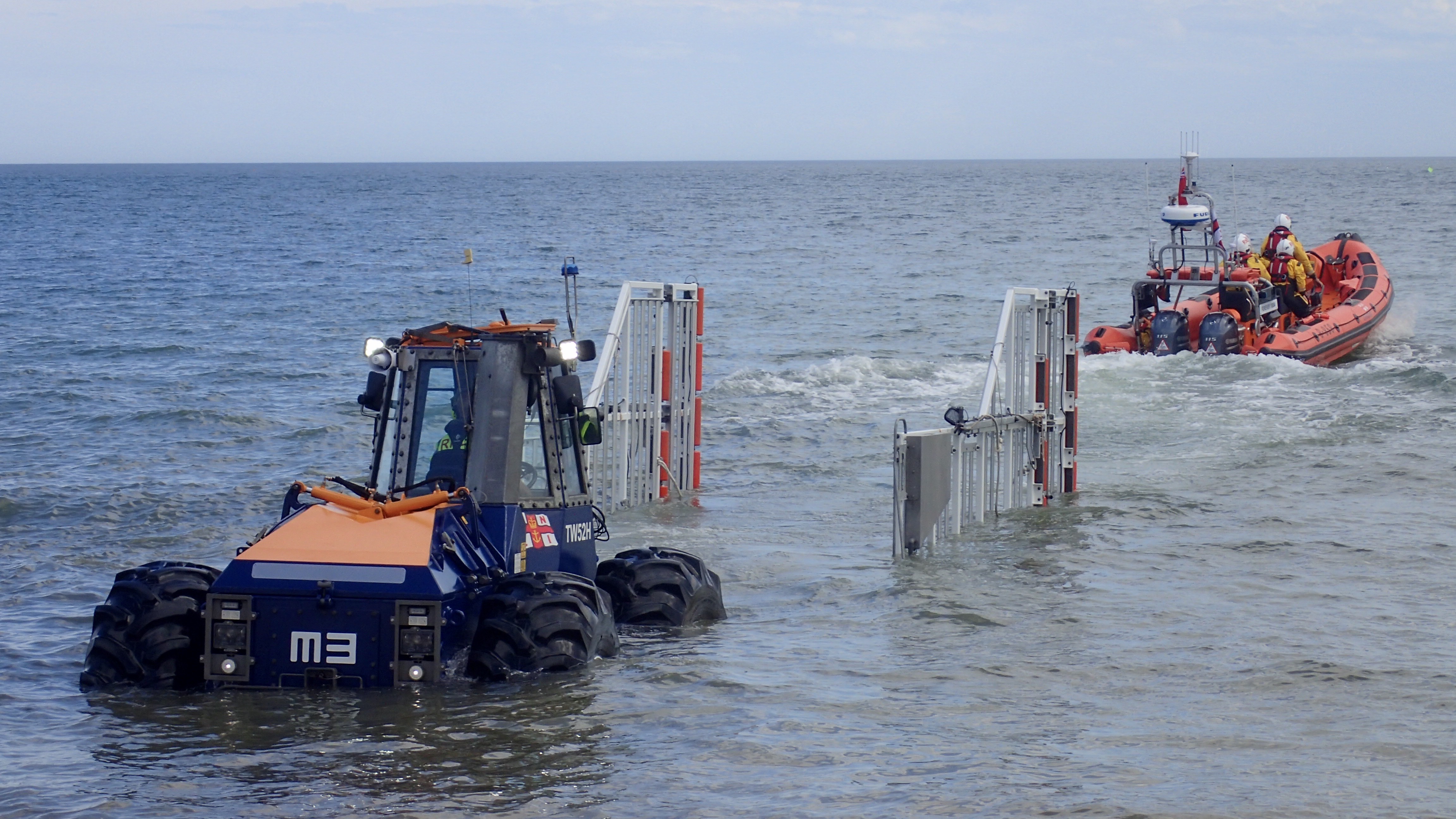 Lifeboat leaving the launching trailer heading out to sea.